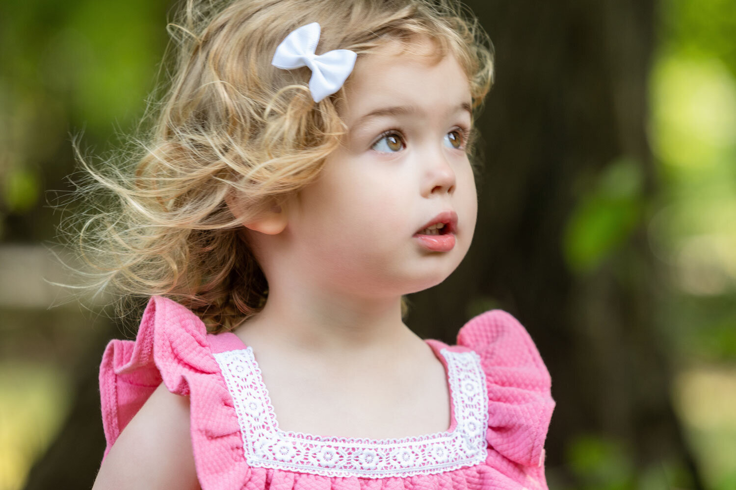 Sweet baby girl in pink with ribbon clip on her hair