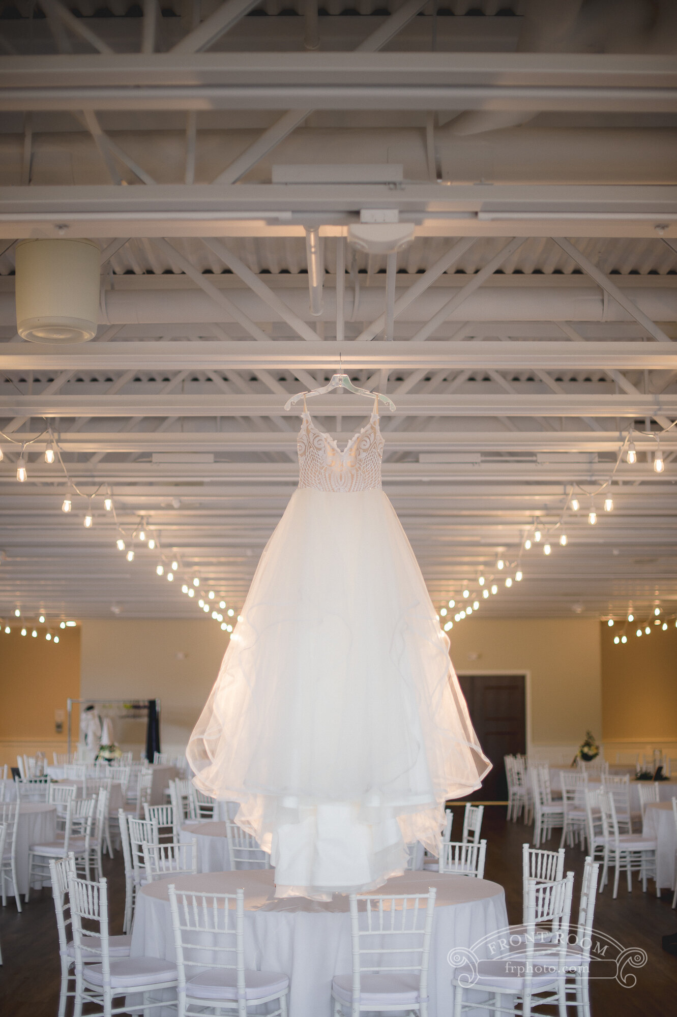 Wedding dress hung in a wedding venue