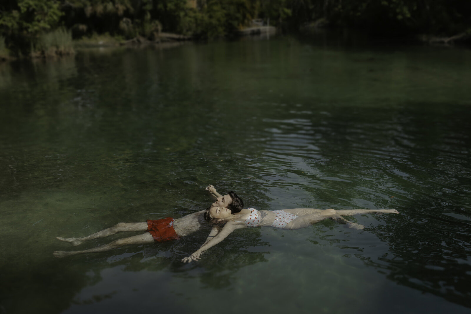 couple floating in a spring taken by their tampa elopement photographer 