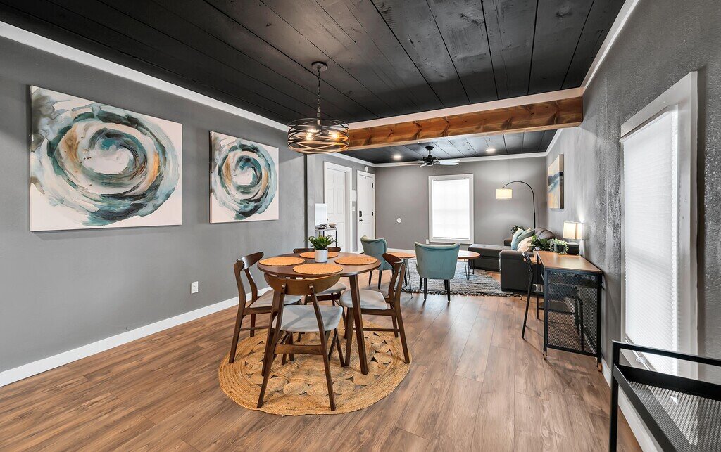 Dining area with view of the living room in this two-bedroom, one-bathroom vacation rental house for five located just 5 minutes from Magnolia, Baylor, and all things downtown Waco.