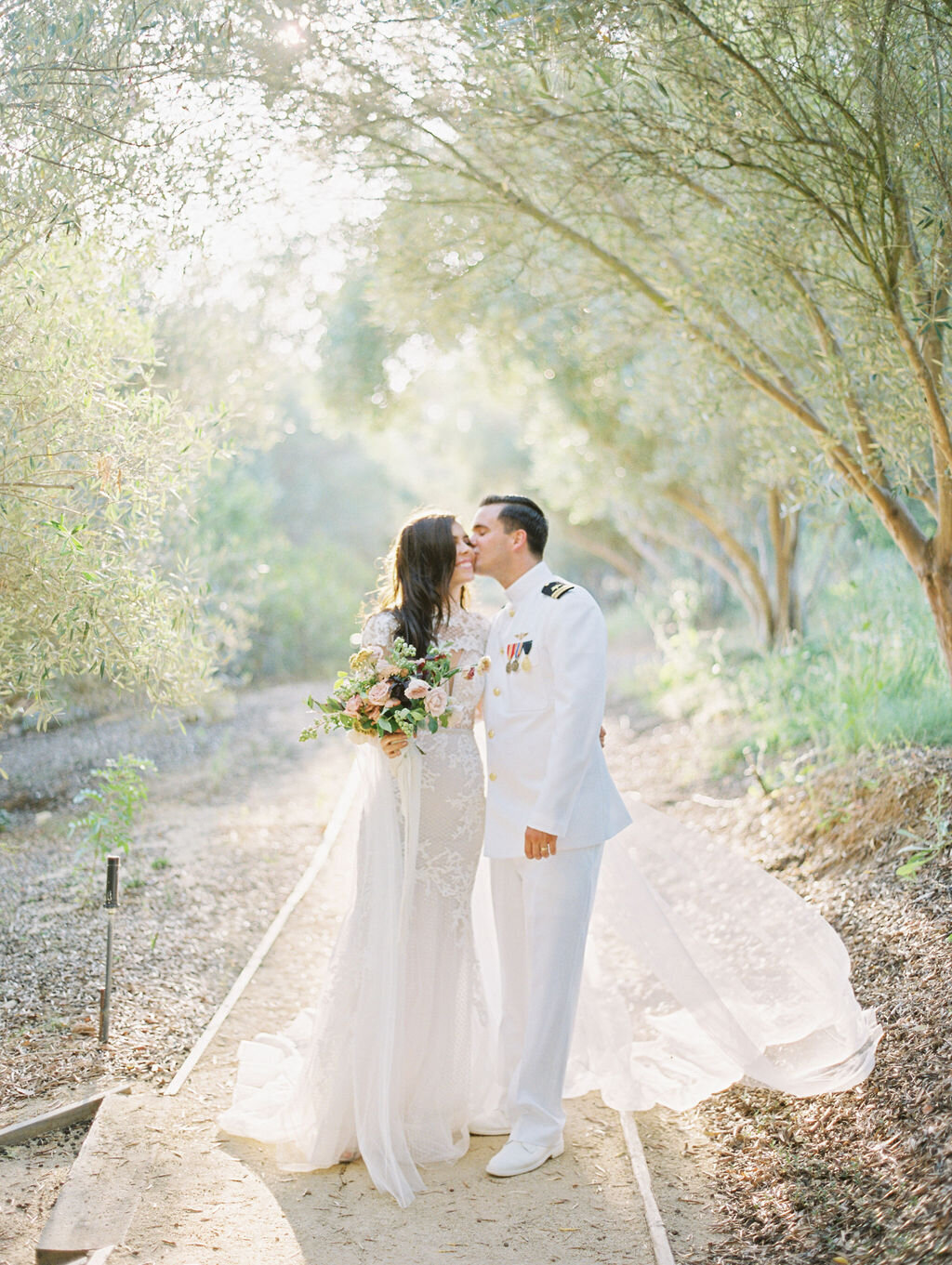 Bride and groom kissing at Rancho Valencia, San Diego wedding