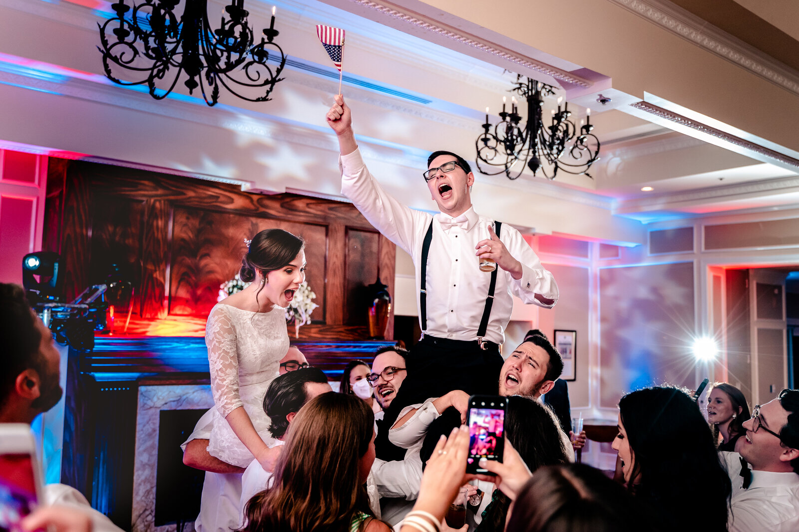 A bride and groom celebrate during their wedding reception at the Country Club of Fairfax after their Catholic wedding in Northern Virginia