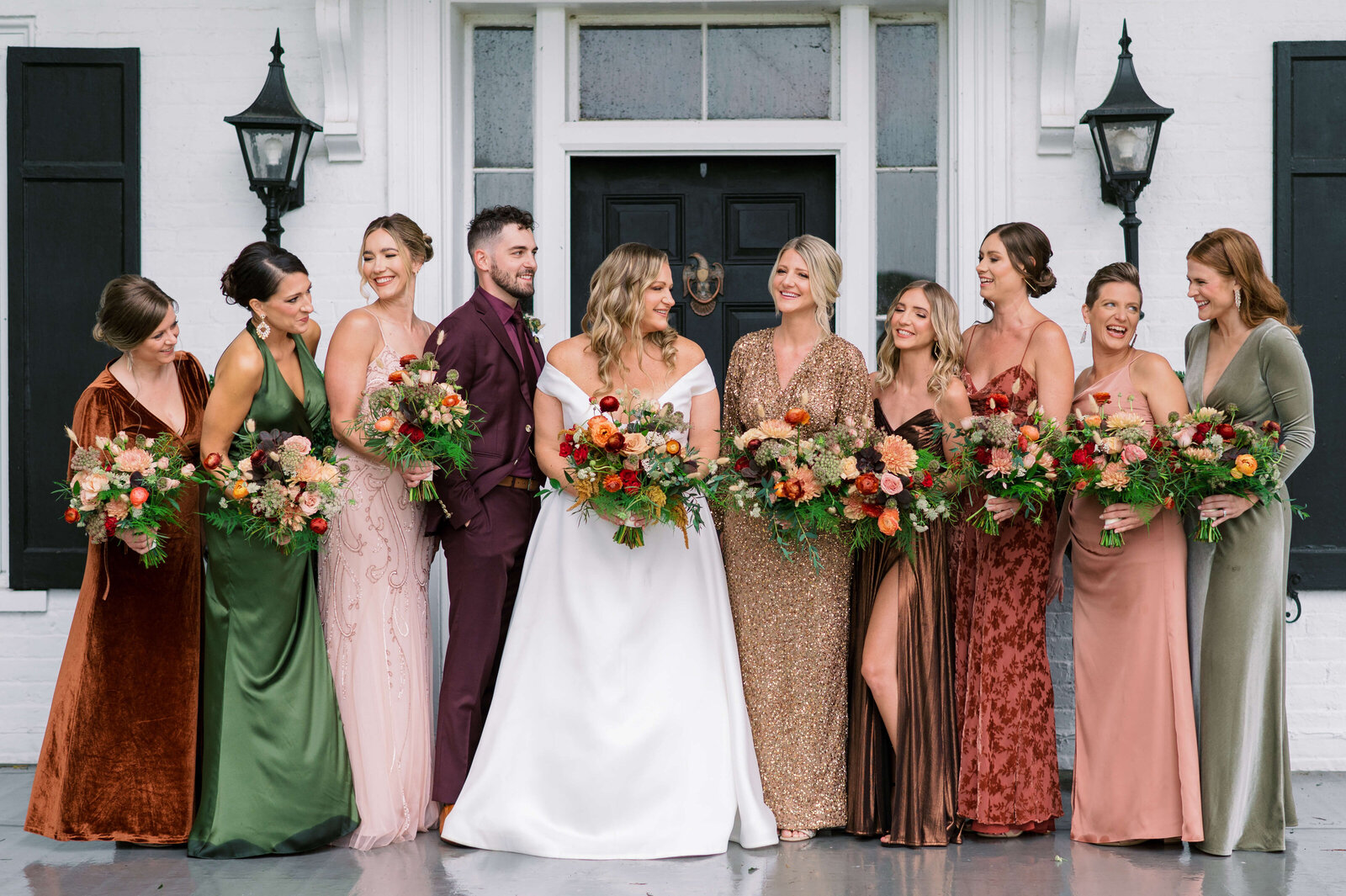 Bridal party in autumn colors laughs together during a beautiful Virginia wedding