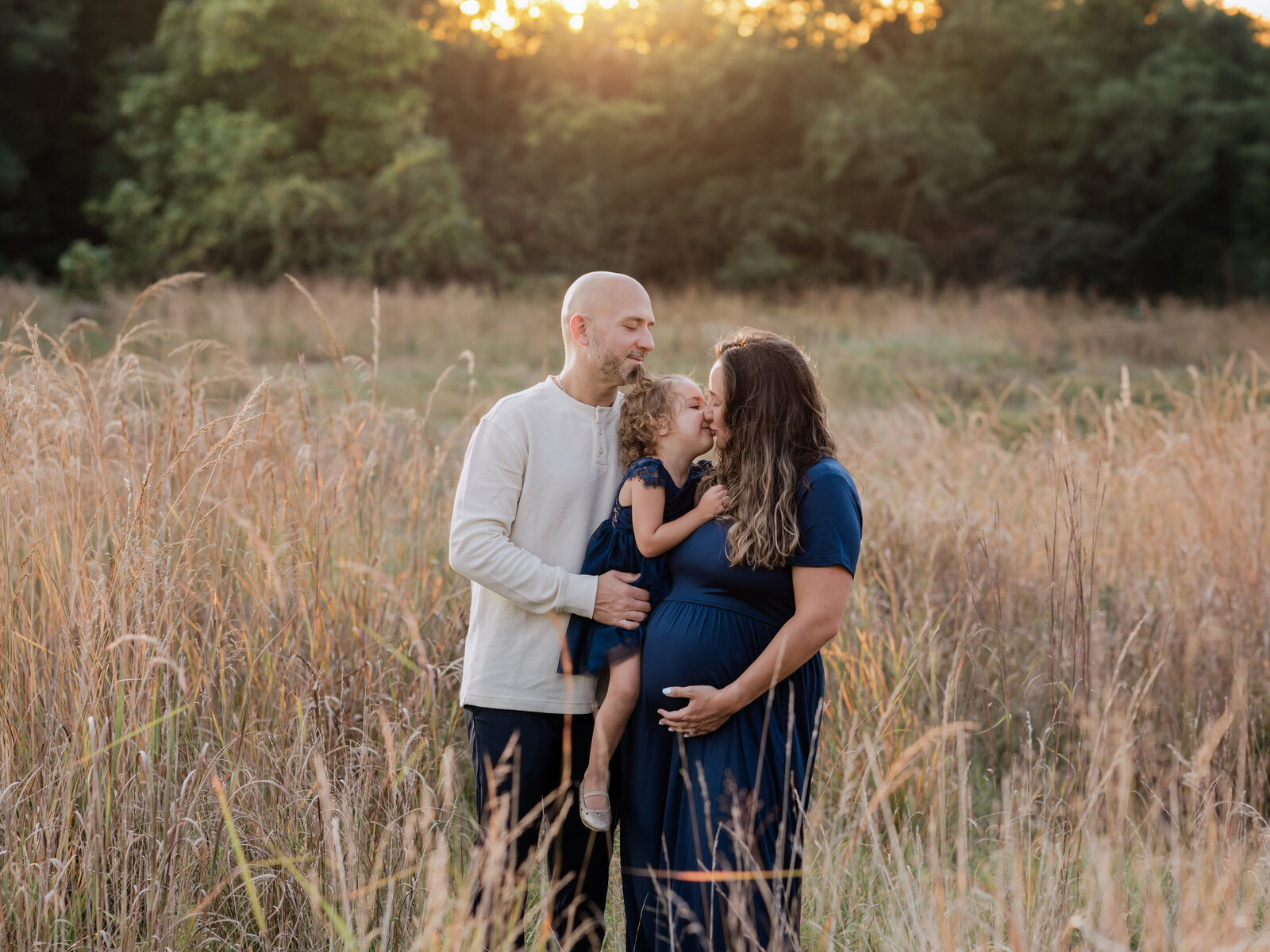 pregnant mother and father holding daughter for maternity photos cleveland maternity photographer