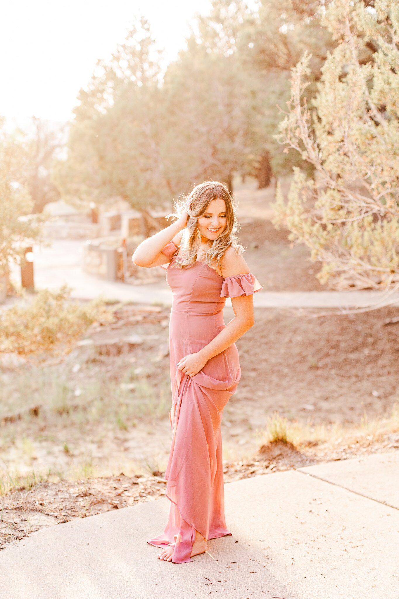 girl standing in pink gown for senior portrait