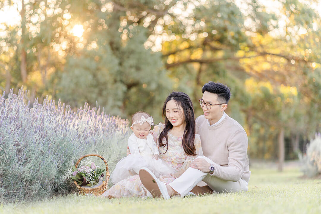 family of 3 during sunset light soft and airy portrait in flowers