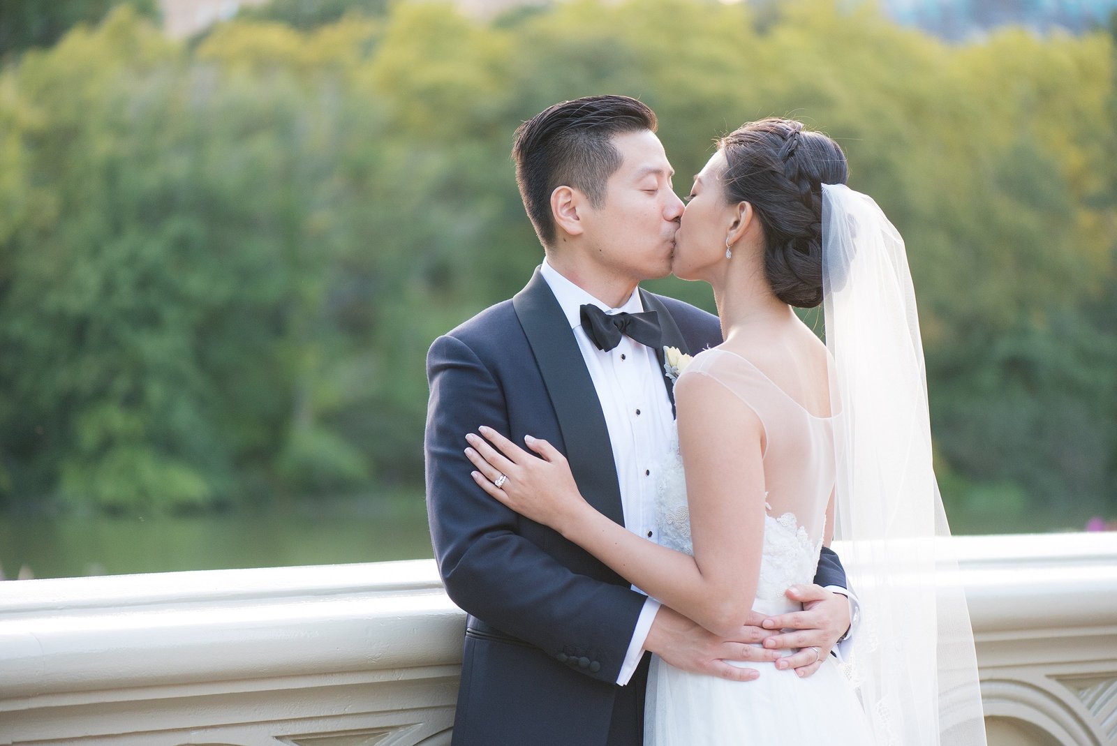 Asian Bride and Groom Kissing on Bow Bridge in Central Park, New York City Photo
