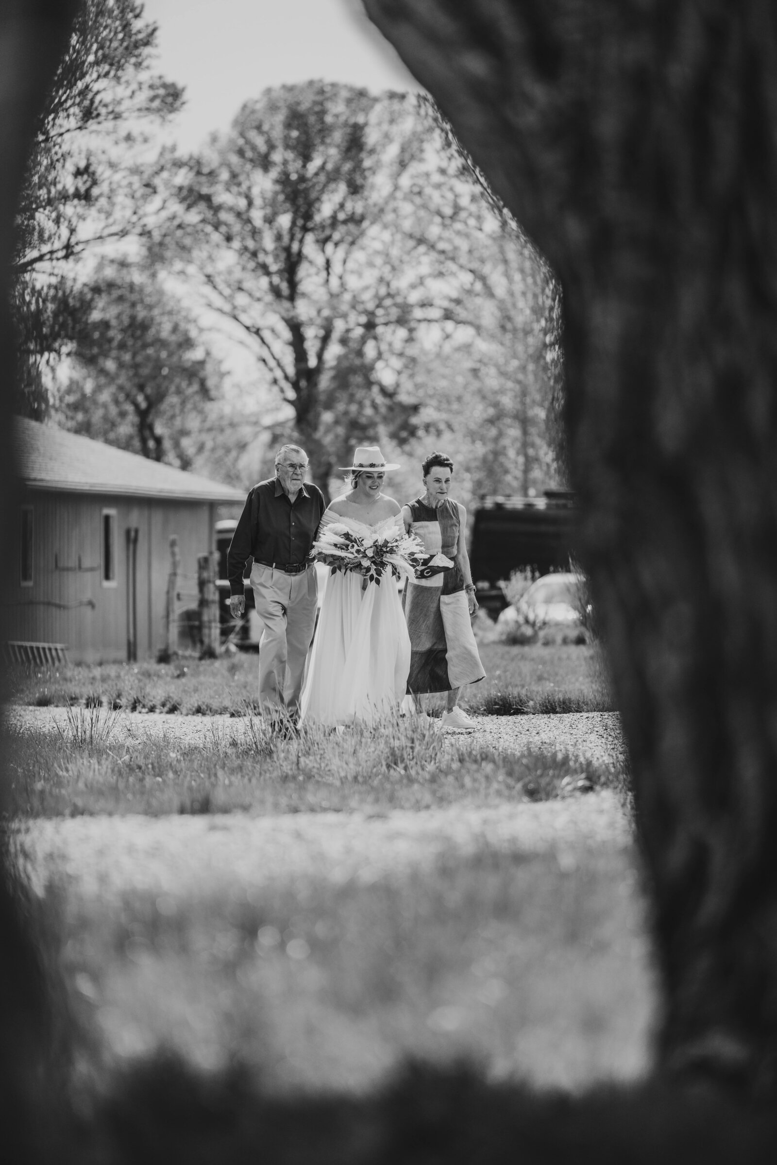 bride walking down aisle with parents