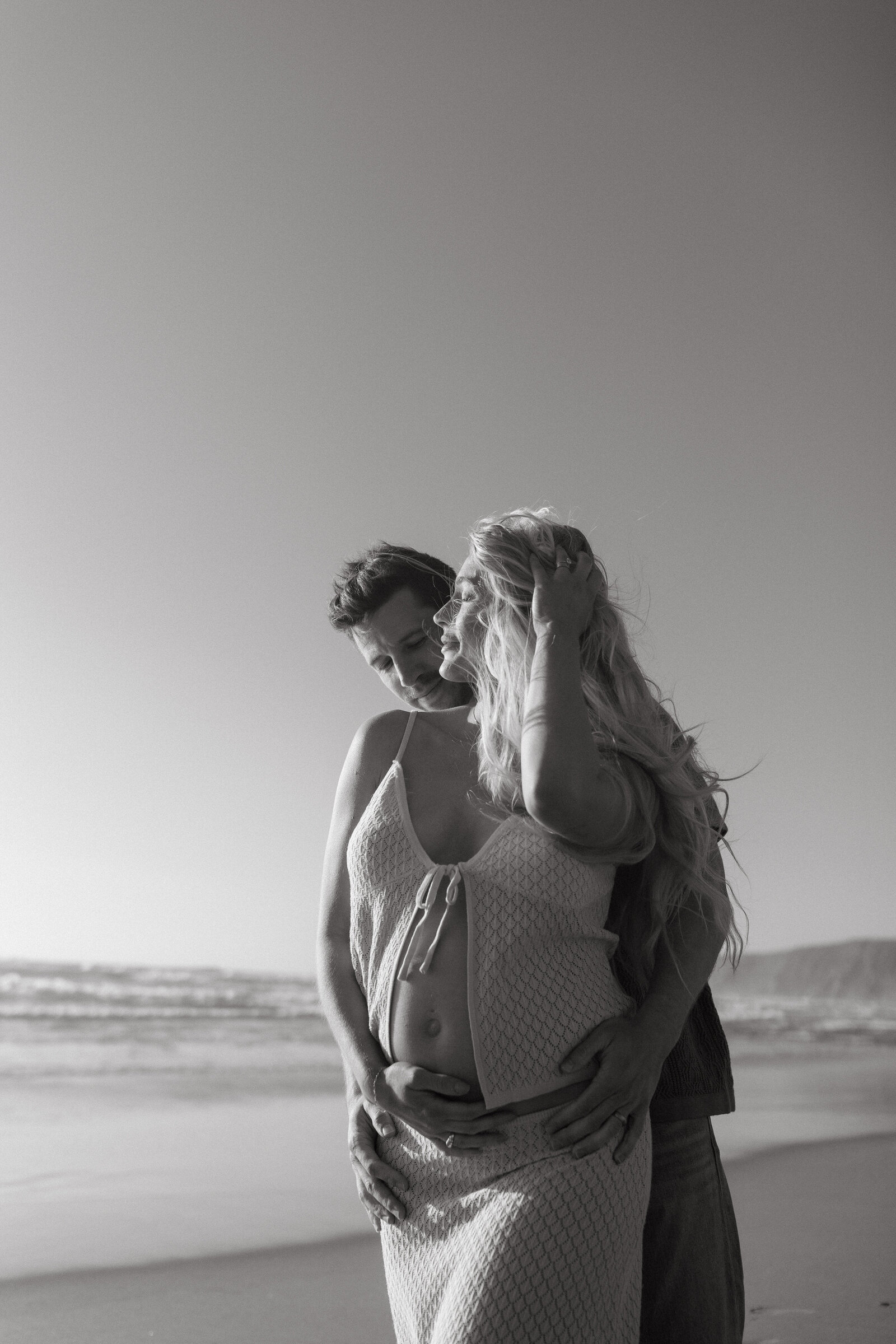 Scenic Point Reyes Beach maternity session with sunlit ocean backdrop