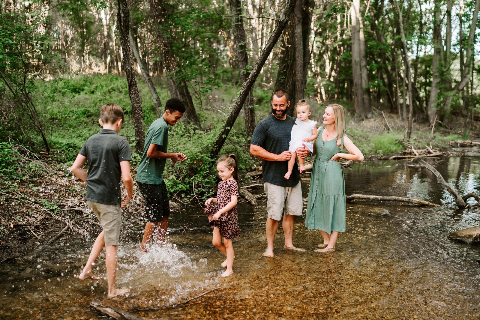 Family playing in creek