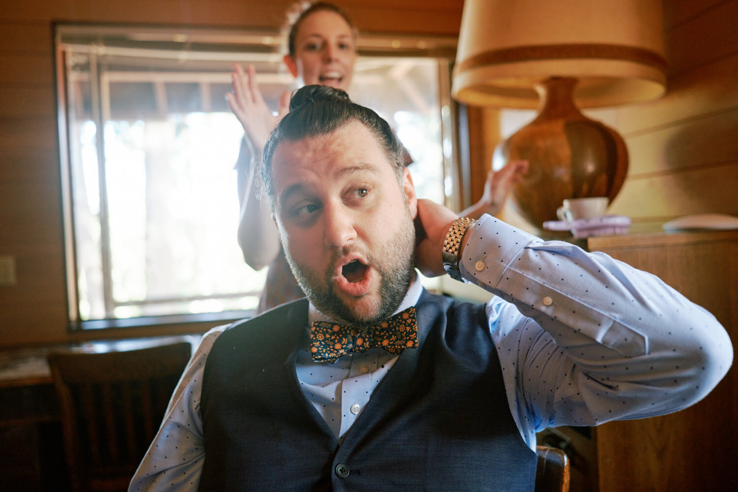 Groom makes an astonished face as he gets ready for the wedding
