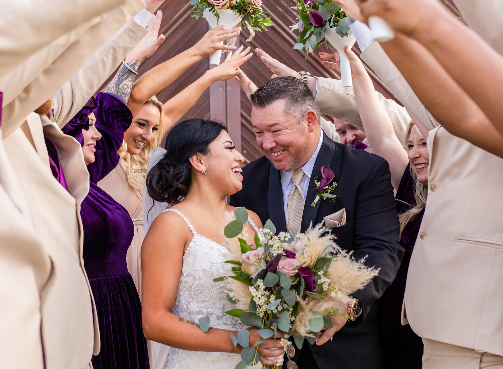 happy married couple and wedding party
