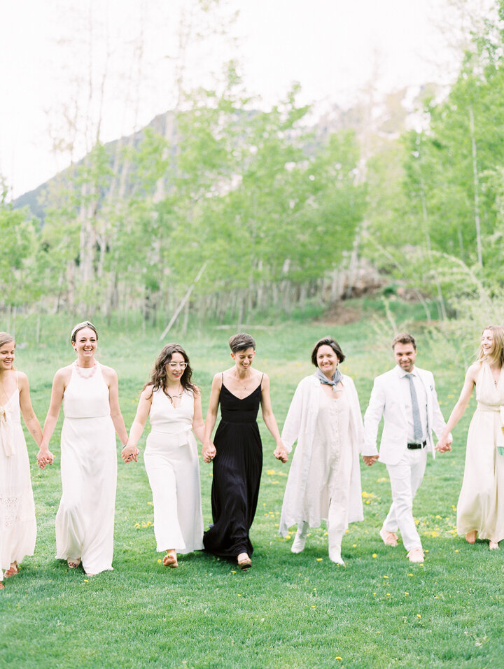 bride wearing black wedding dress and bridesmaids wearing white