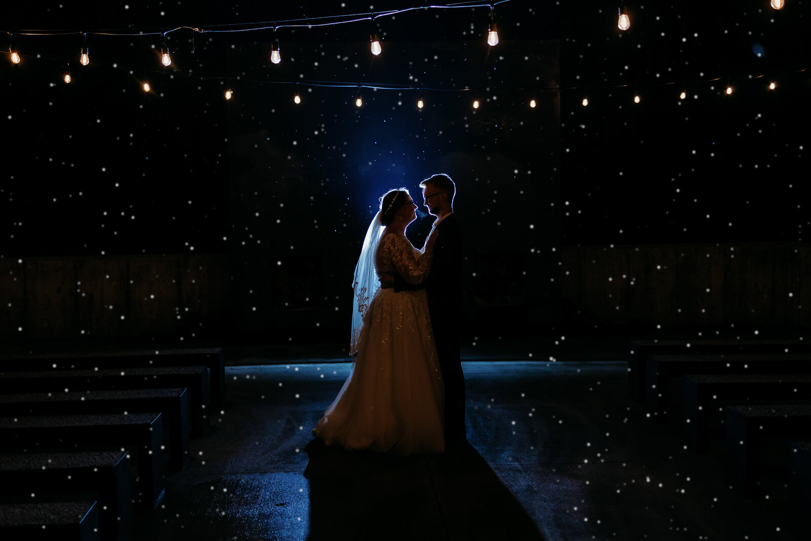 Beautiful back lit photo of a couple embracing on their wedding day