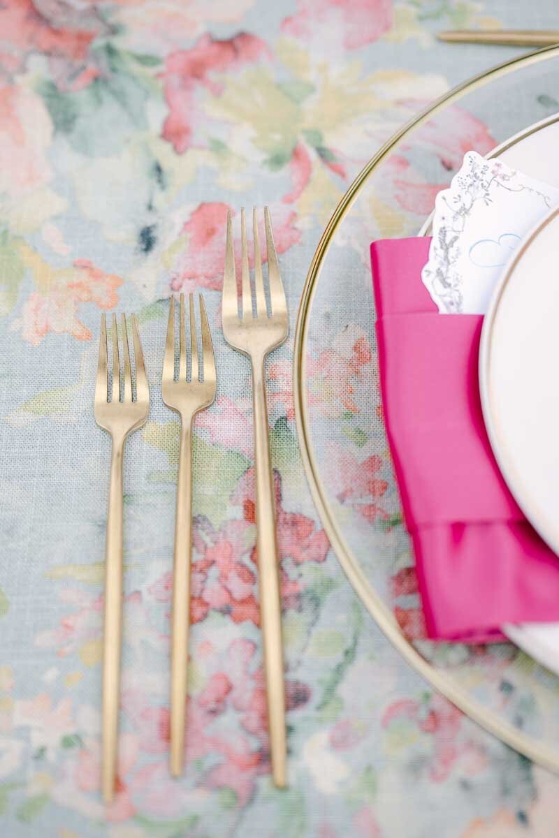 close up detail shot of golden dining forks and plate