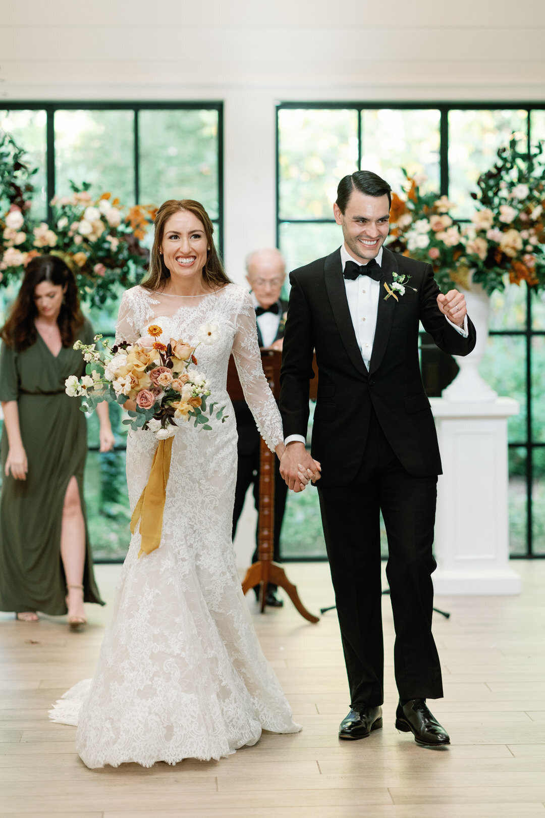 bride and groom smiling exiting wedding ceremony at The Orchard House at Old Edwards