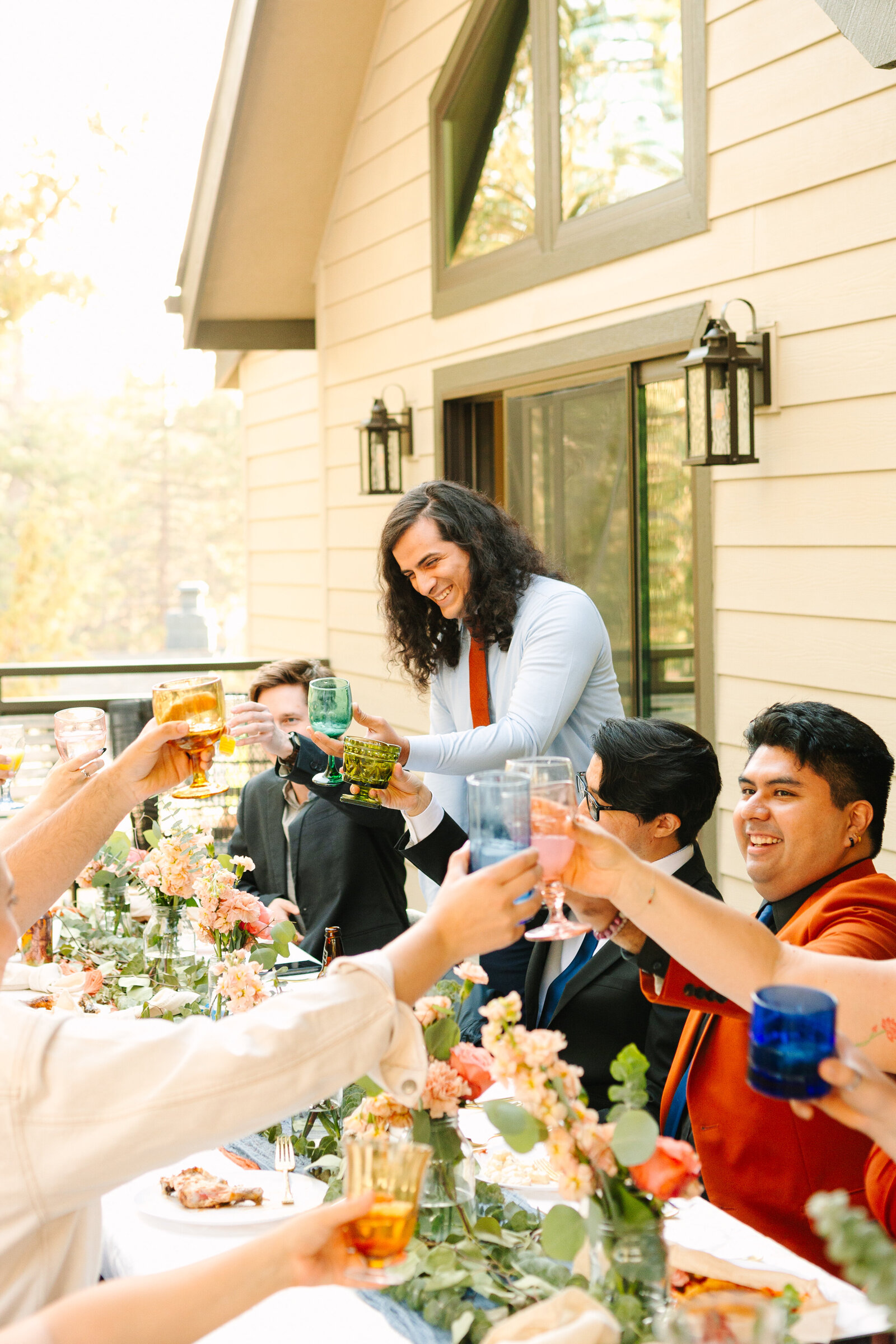 The bridal party celebrates an intimate elopement at a cabin at Big Bear Lake, California.