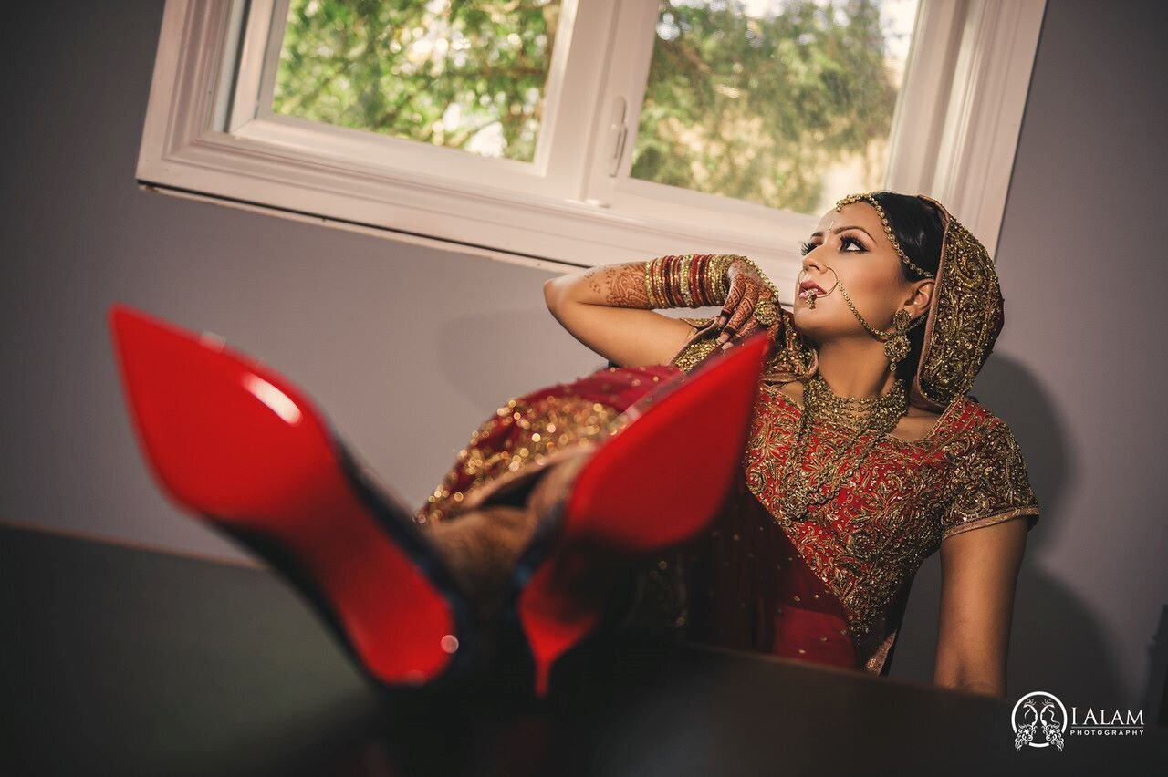 Indian bride in Ottawa radiates joy, adorned in vibrant lehenga and jewelry, makeup by Red Carpet Glamour.