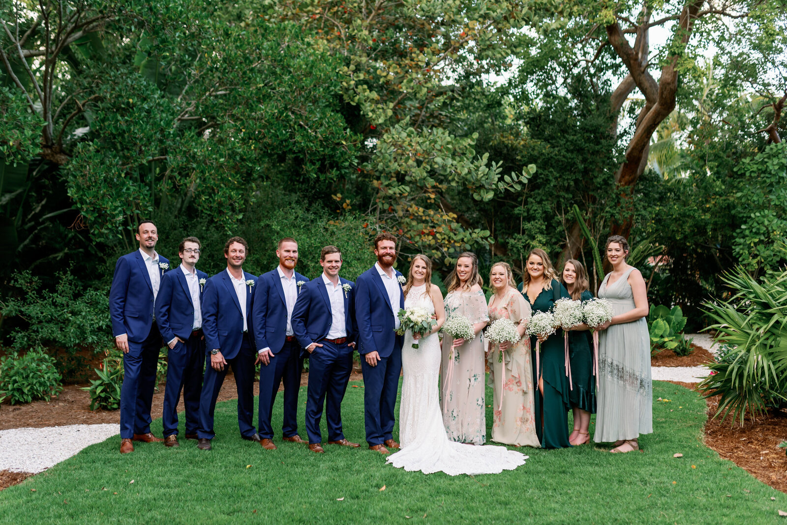 Entire bridal party smiling on a manicured lawn on Captiva Island, FL