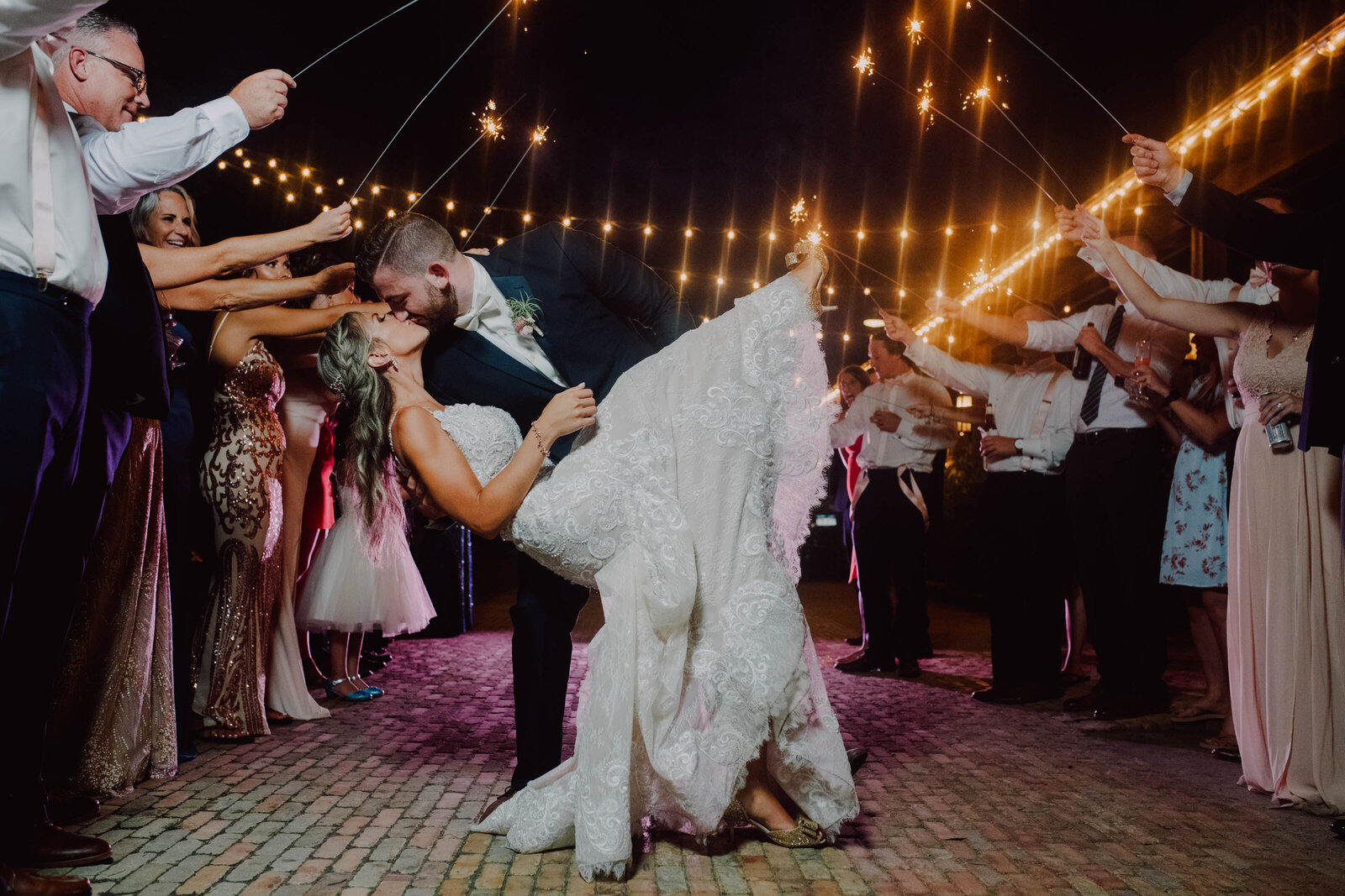 bride in beautiful lace dress looks up at her groom in a blue tux as they share a first dance durham hill farm shot by philadelphia wedding photographer alex medvick