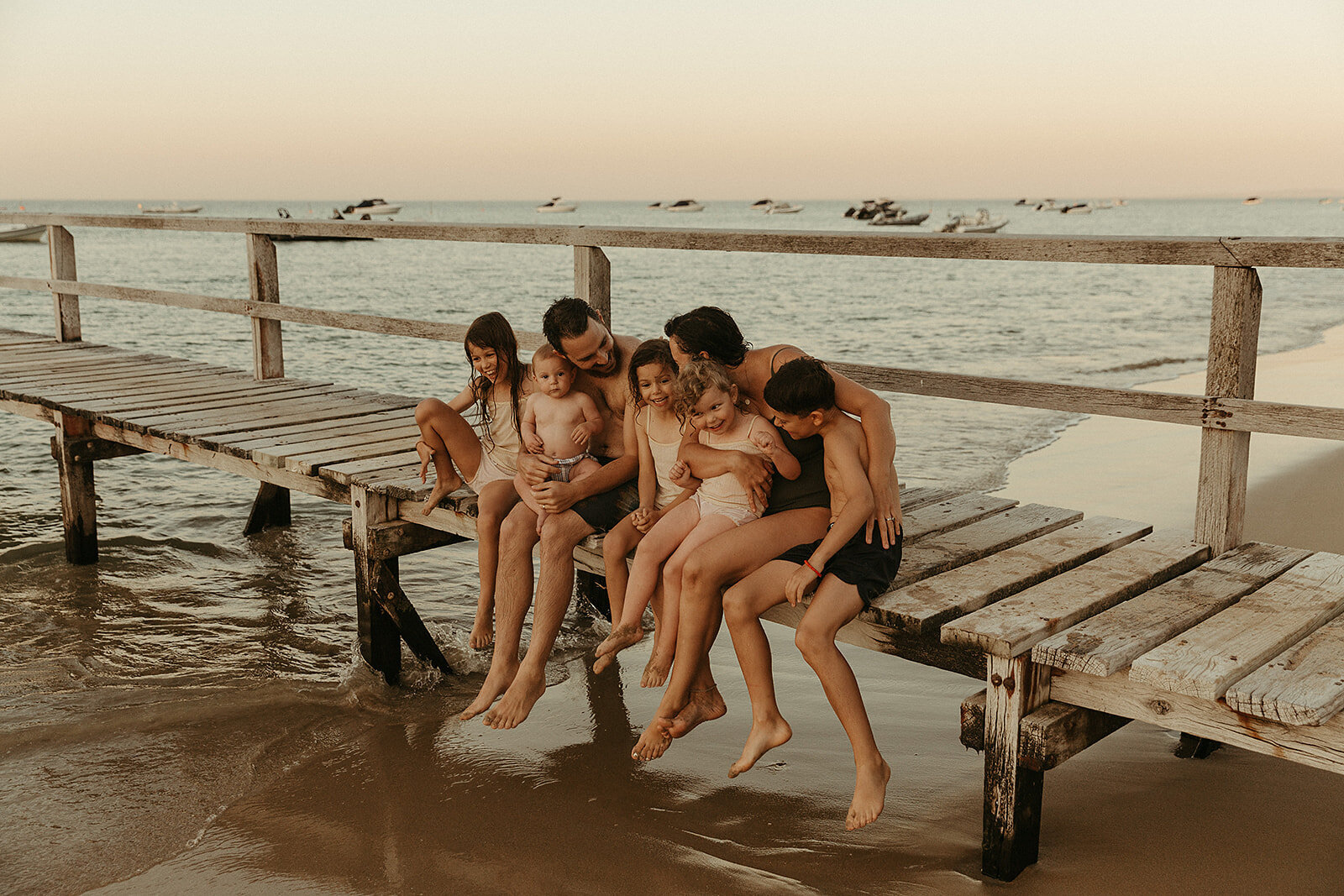 Family laughing together on their front porch in Gippsland