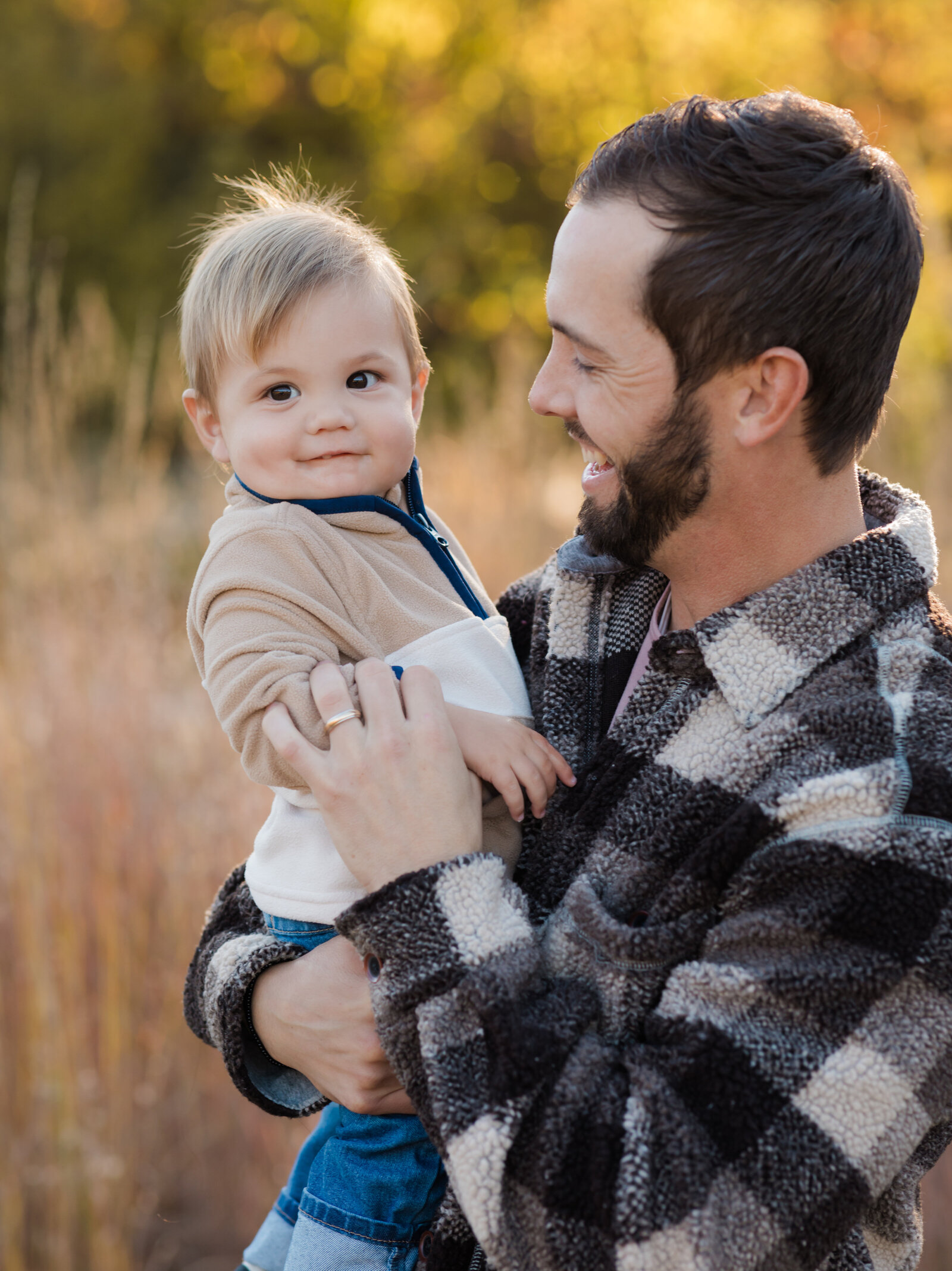 dad holding his son for family photos