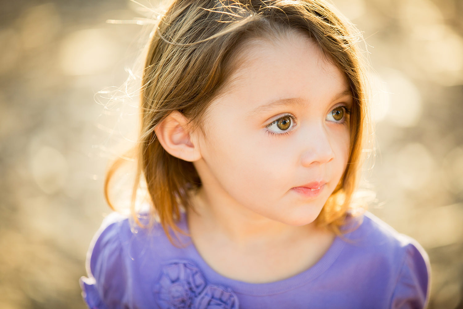 san diego family photographer | little girl looking away from camera hair blowing in the wind