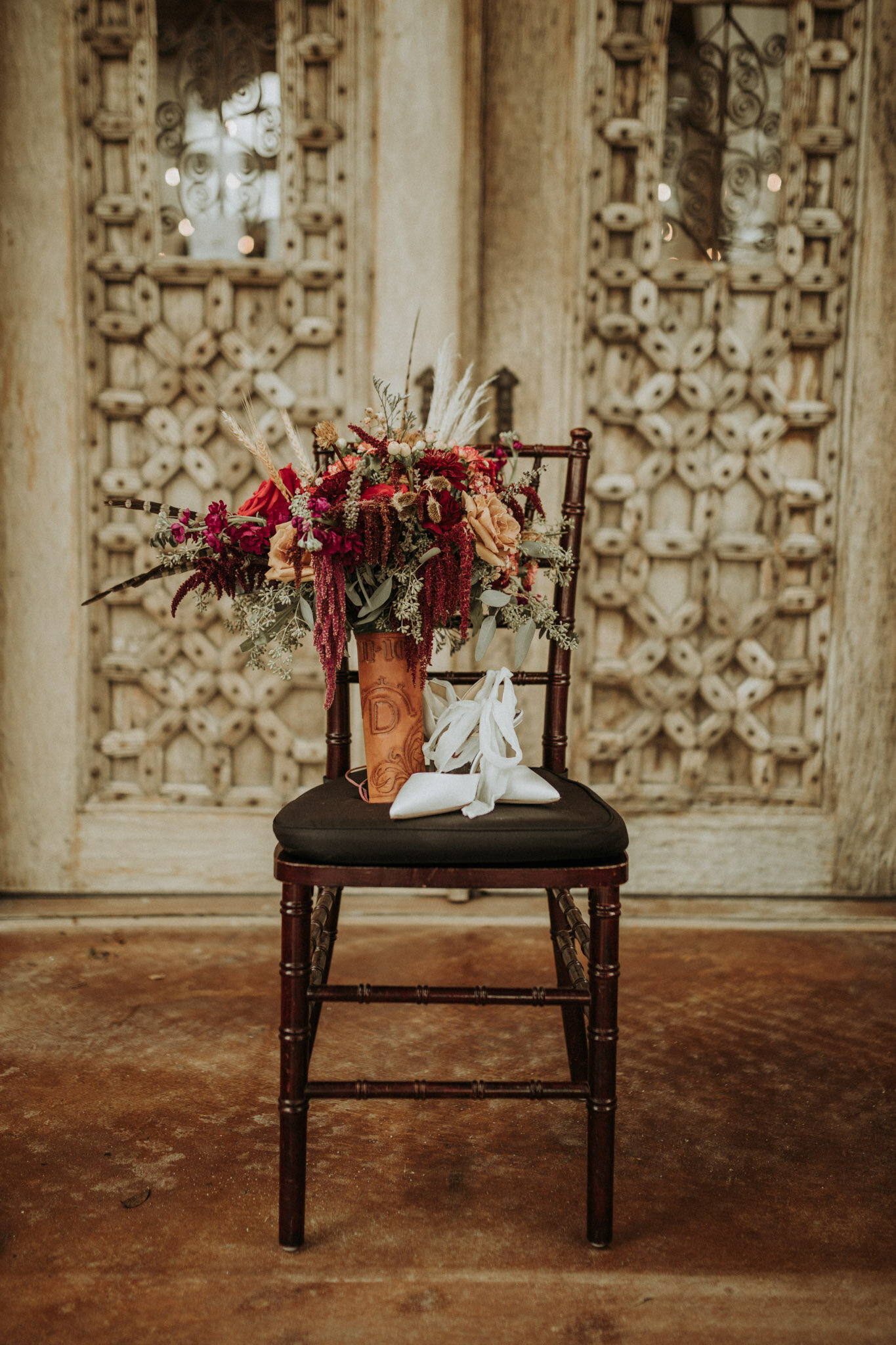wedding shoes and florals on a chair