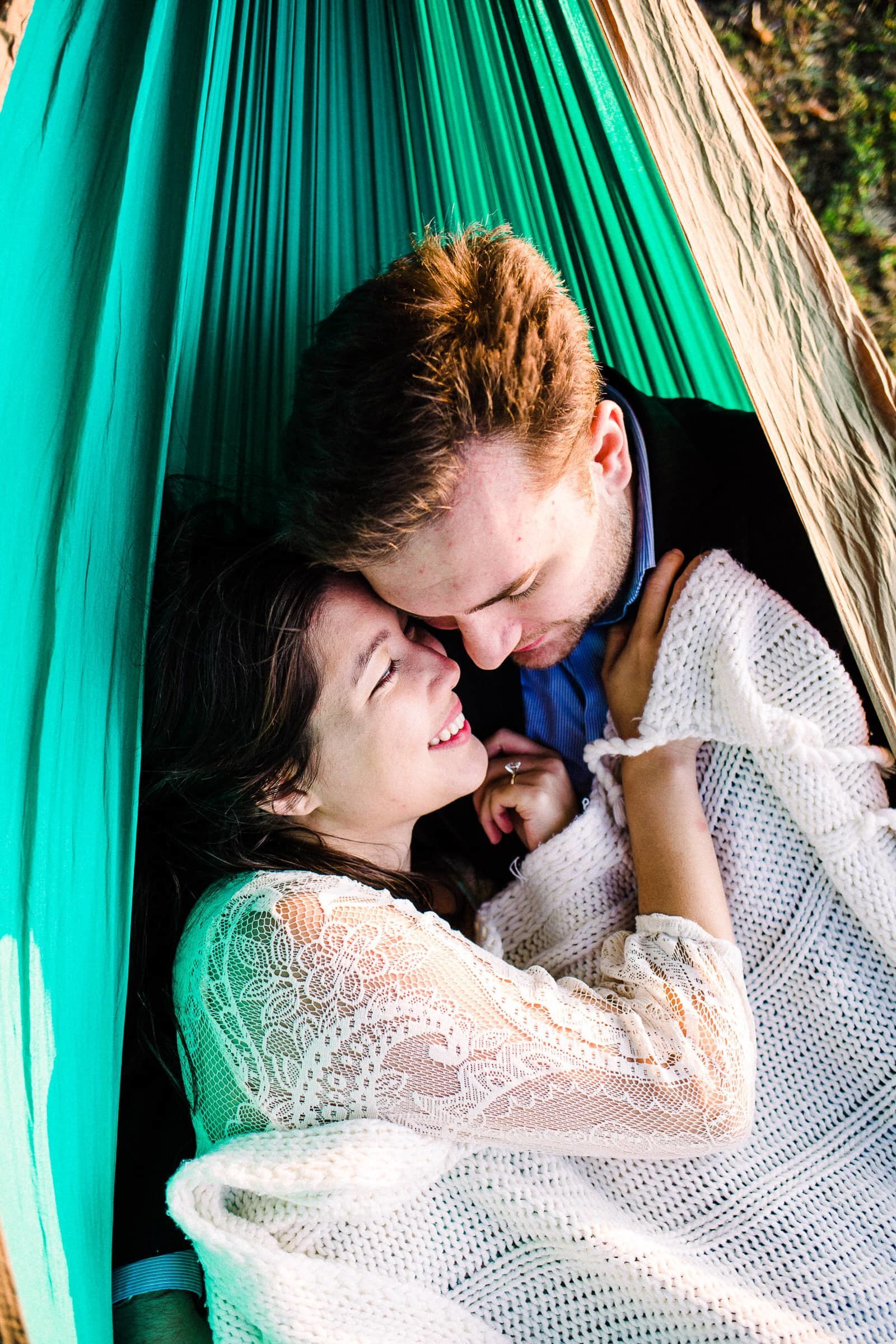 Couple snuggling in hammock in PNW