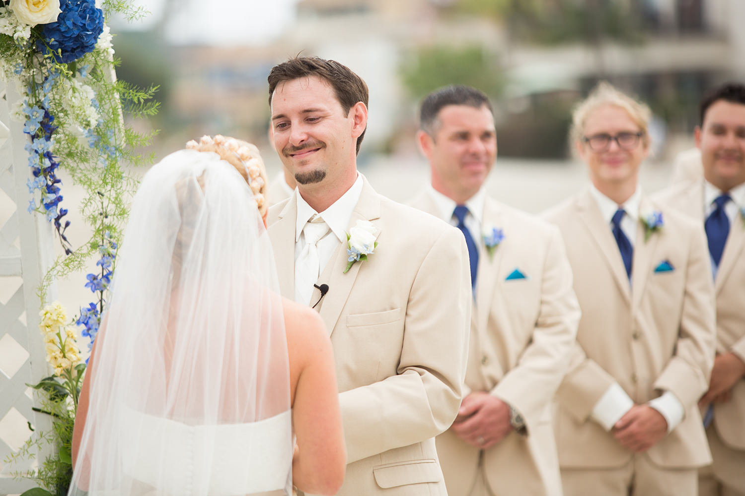 couple saying their vows blue and cream flowers