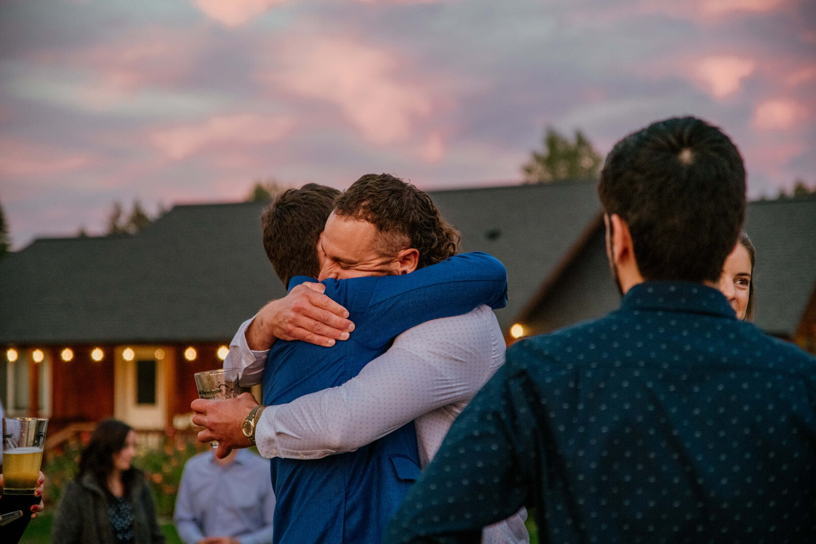 Friends embrace the Groom.