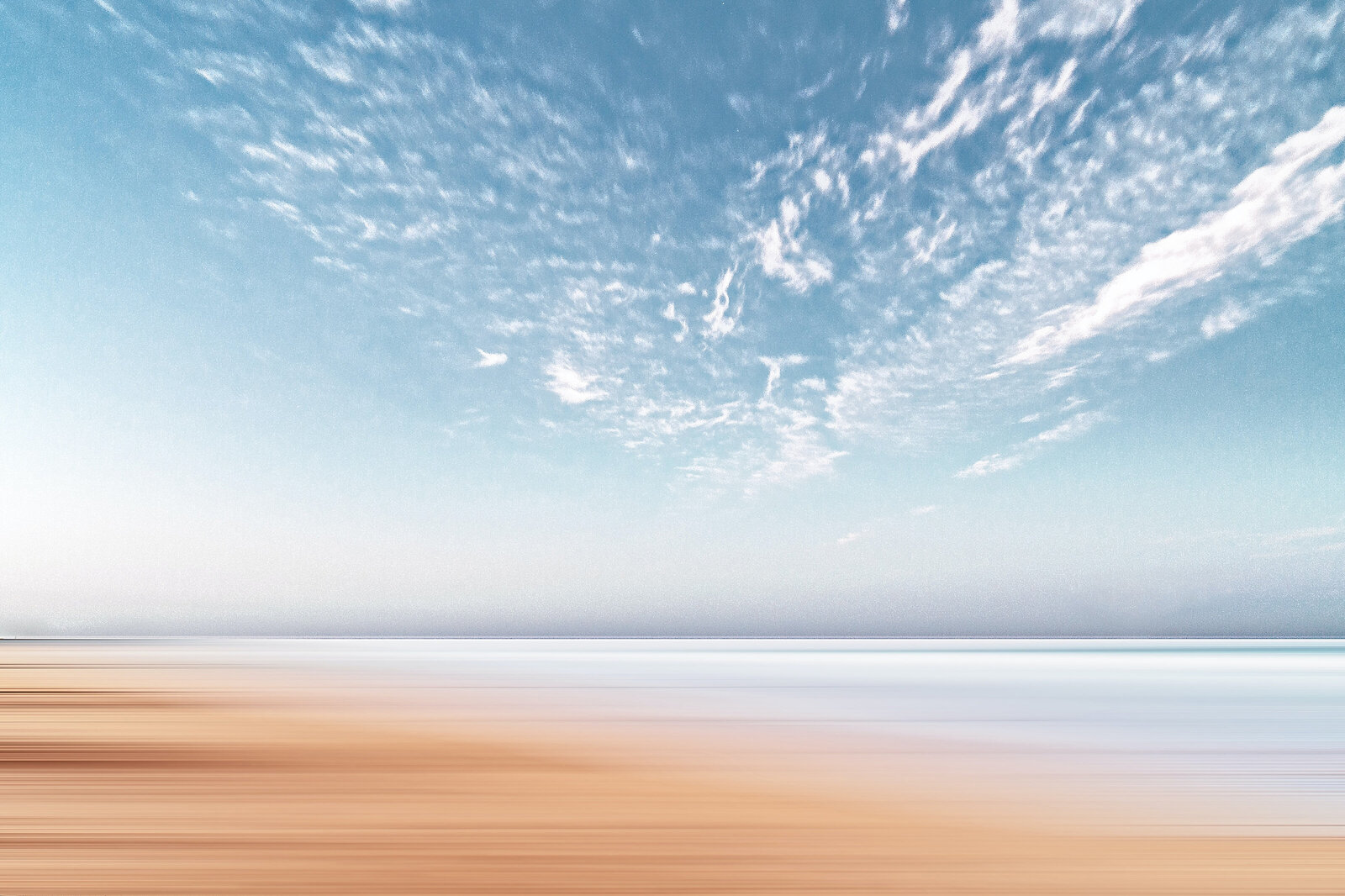 Beach scene with blue sky, ocean and sand