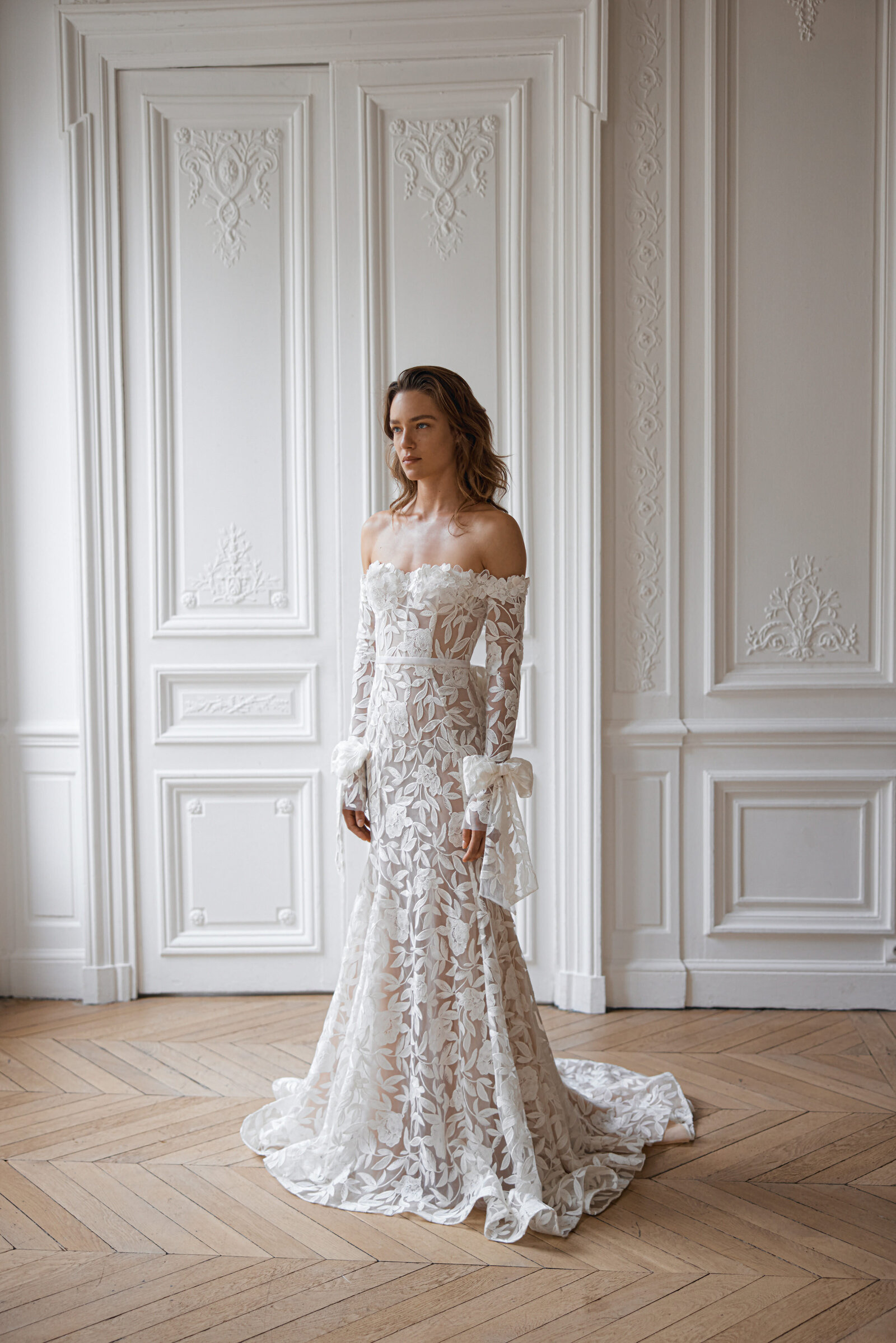 bride wearing strapless white lace wedding dress with long sleeves