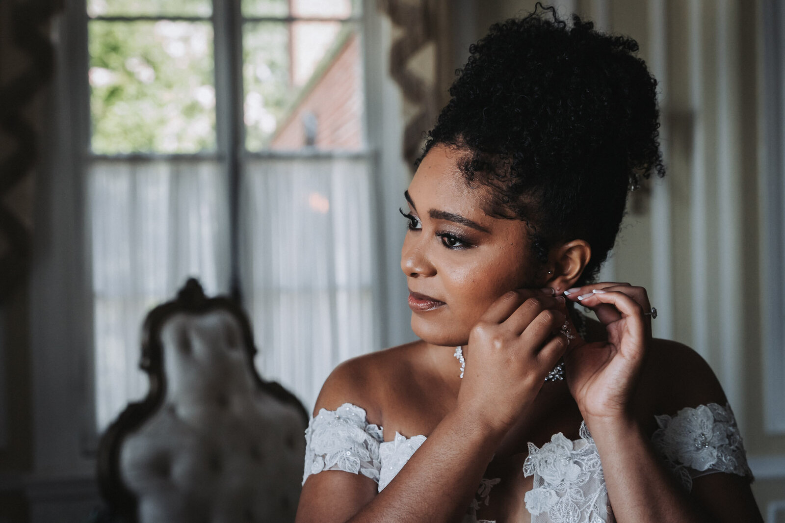 Bride setting earings - Baltimore wedding photography