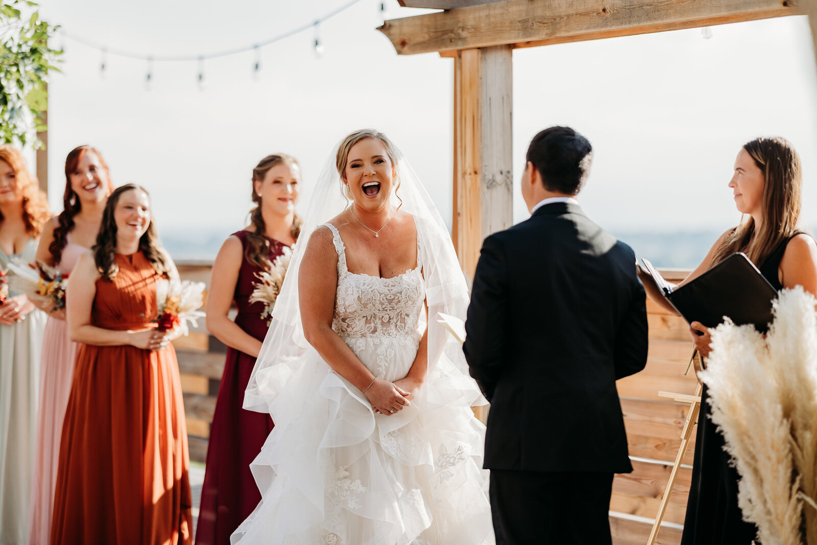 Colorado Elopement Photographer captures bride laughing during vows at cabin wedding ceremony