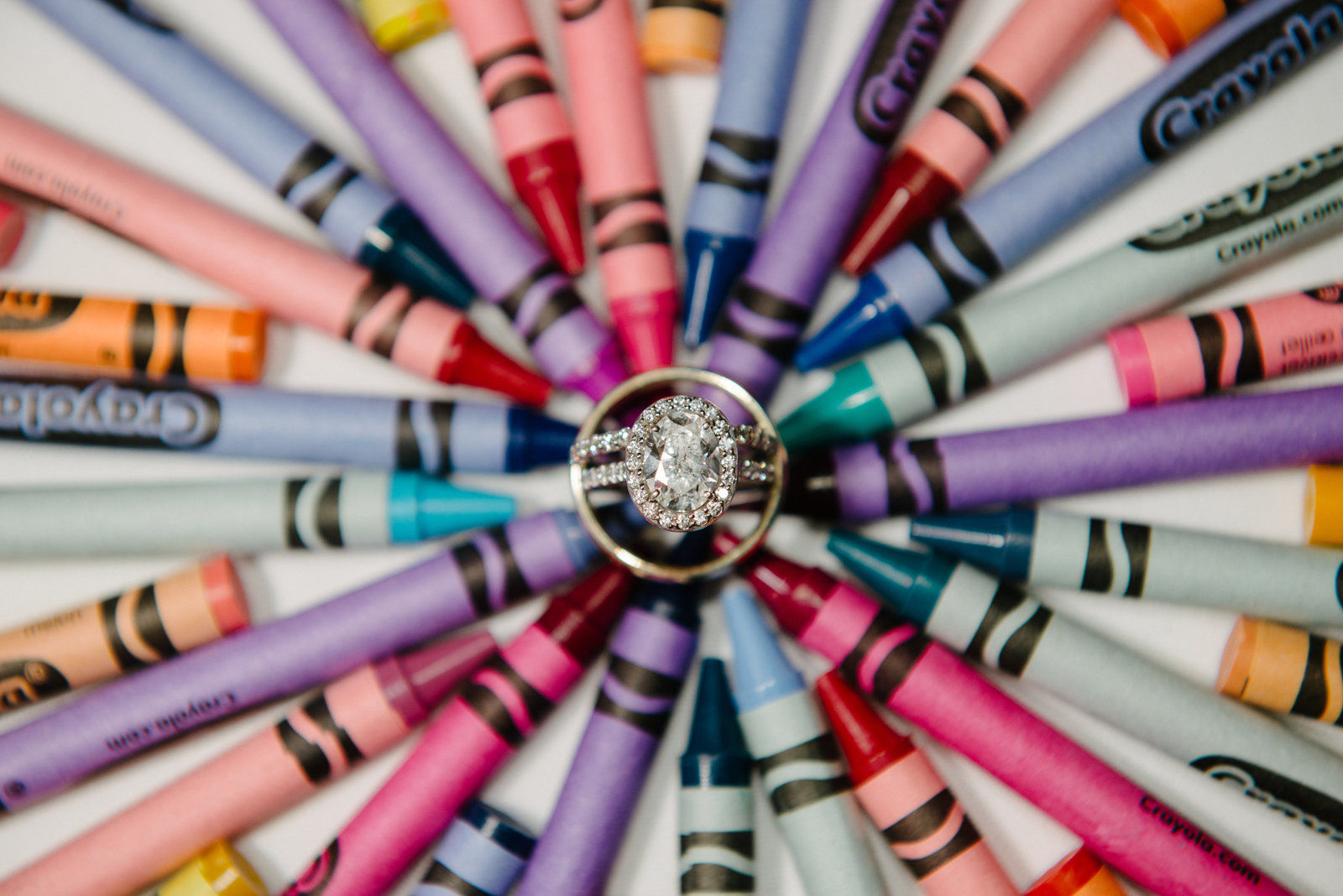 creative wedding ring photo on top of crayons