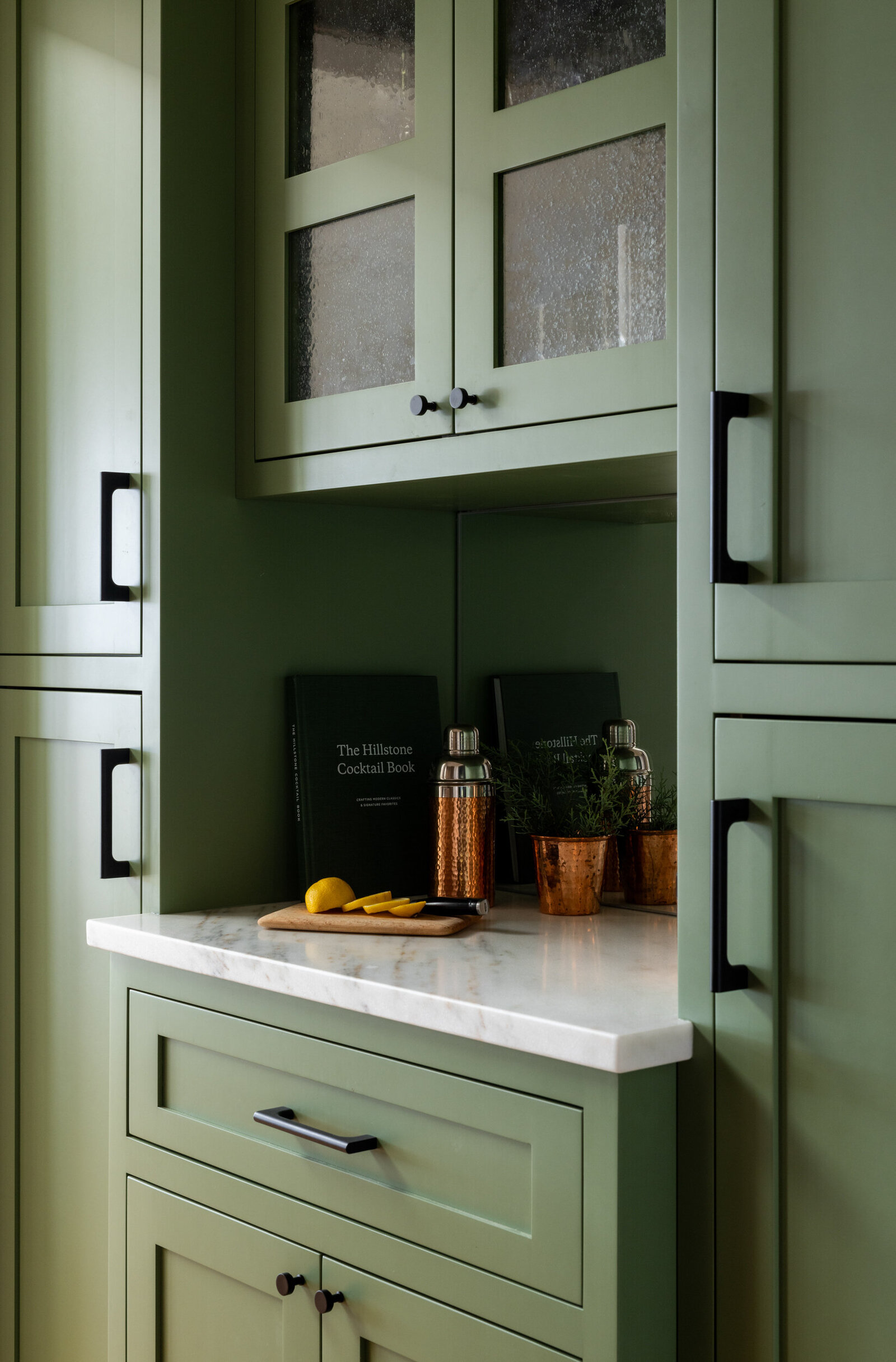CUSTOM BAR WITH GREEN PAINT AND MIRRORED BACKSPLASH