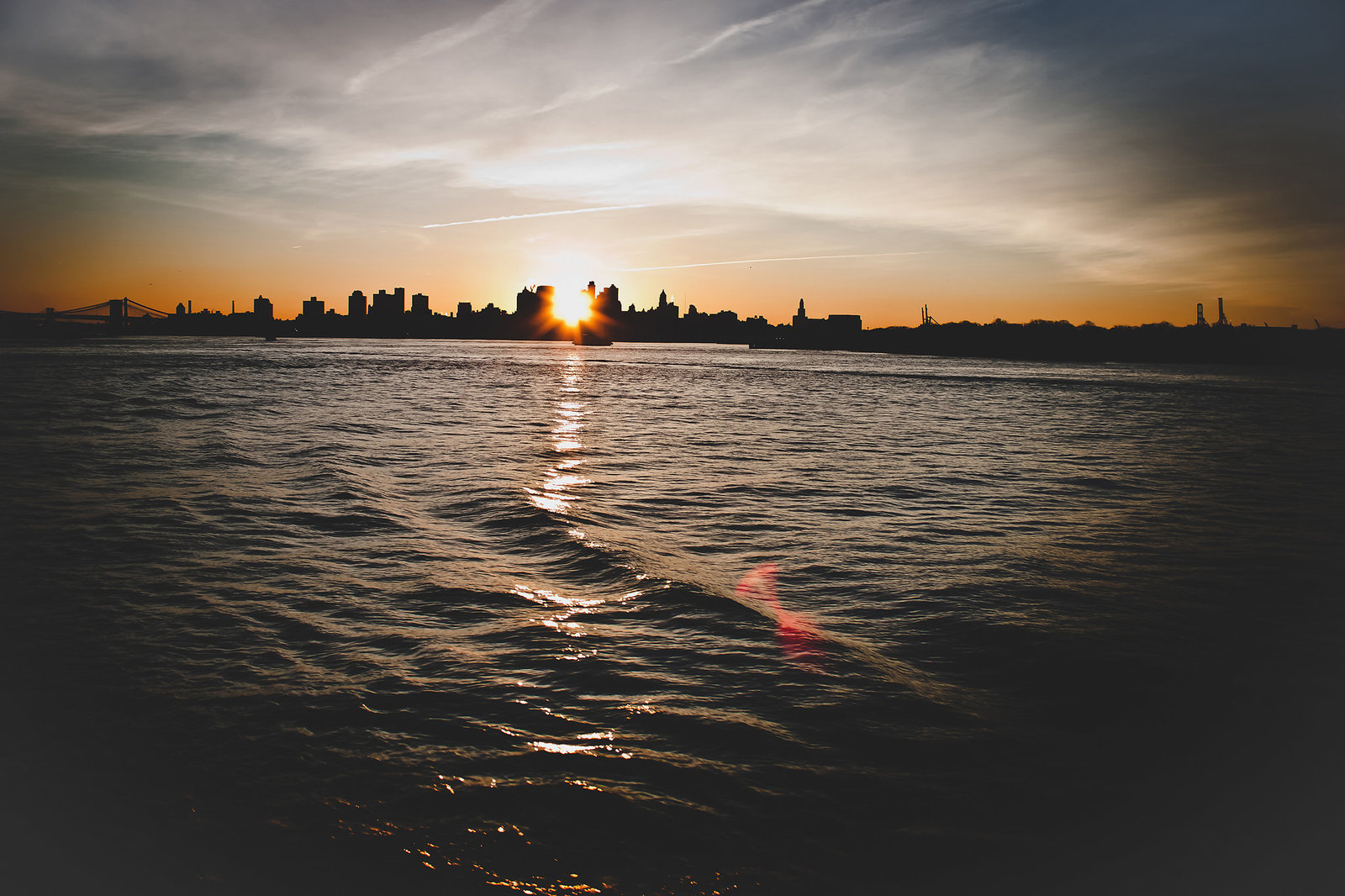 New York City skyline over the water at sunrise