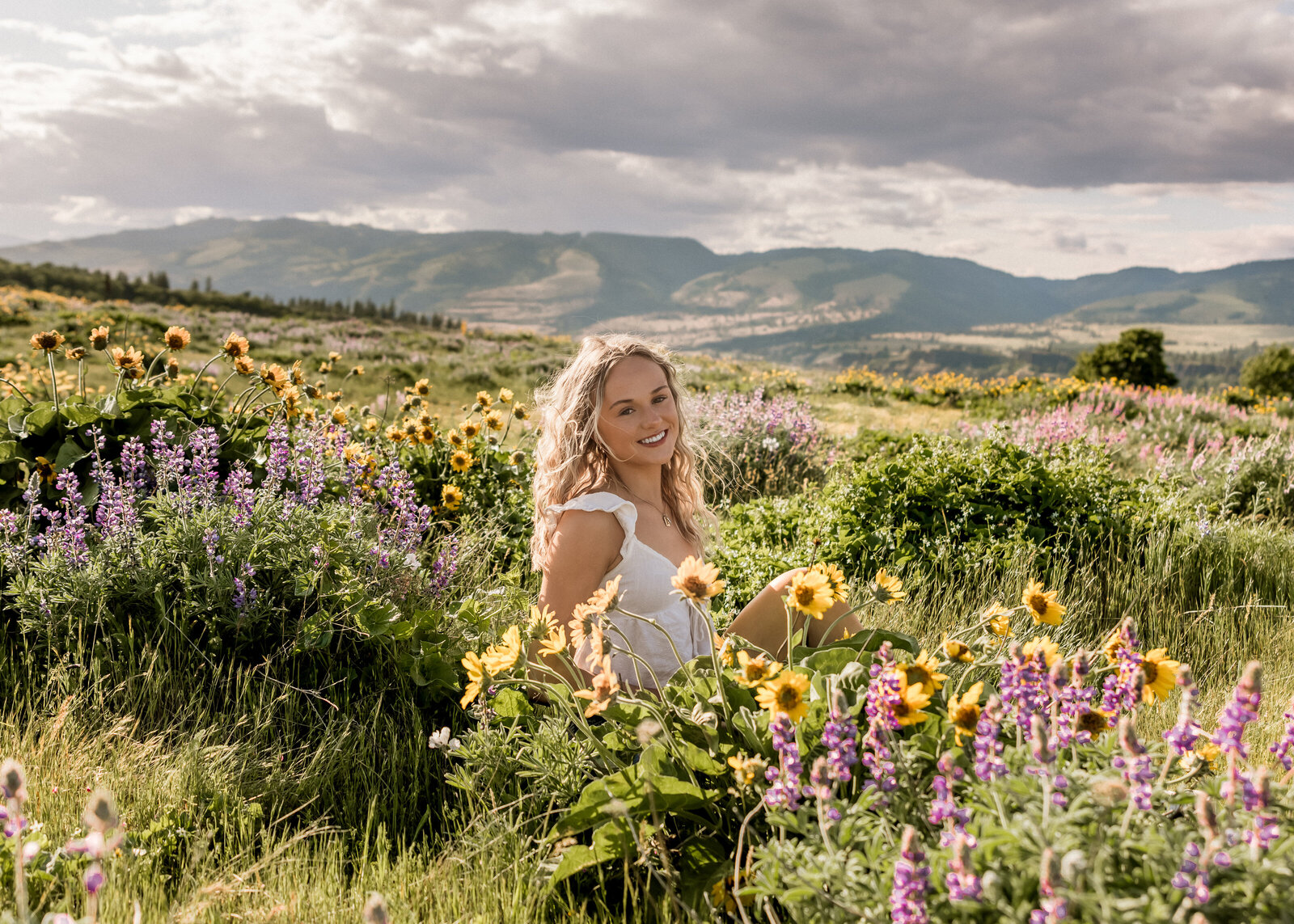 Girl sitting in a field of wildflowers in the Columbia River Gorge