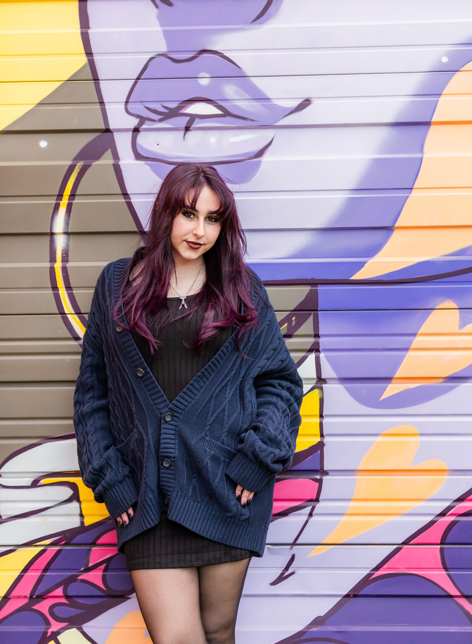 artsitc senior girl by mural
