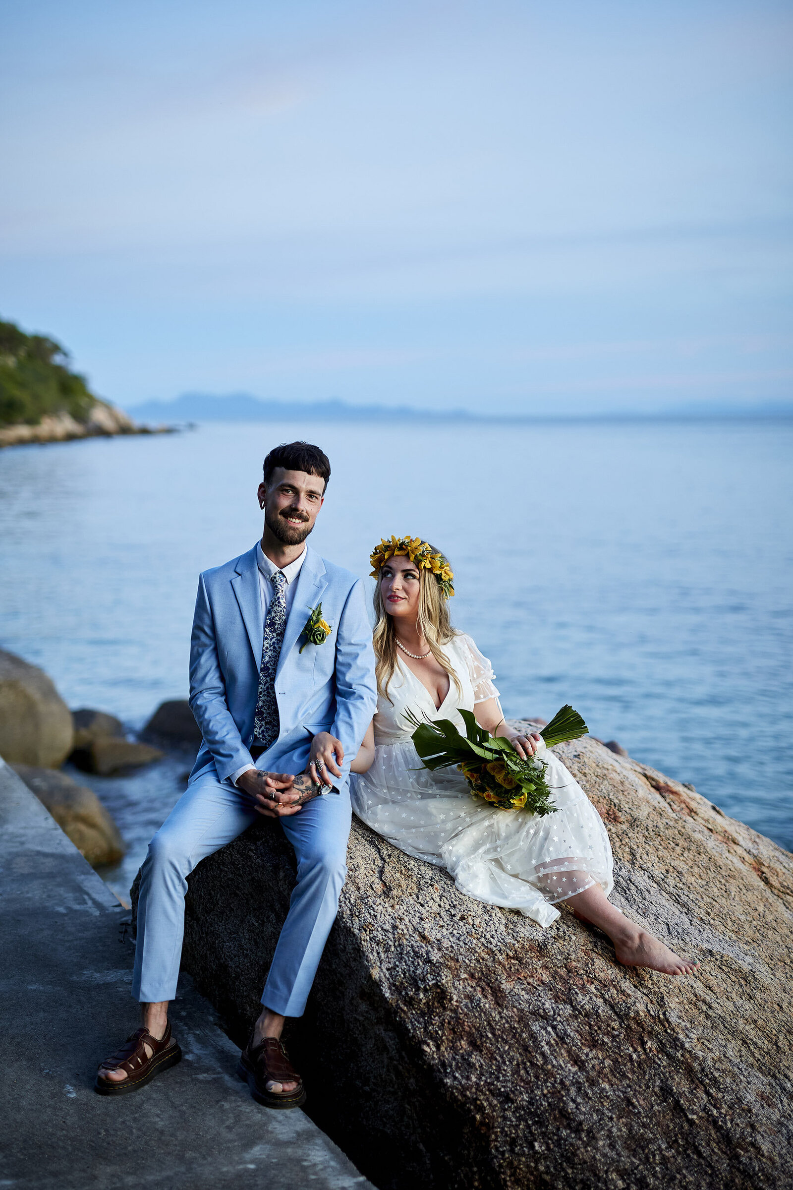 Bride and Groom sitting on rocks