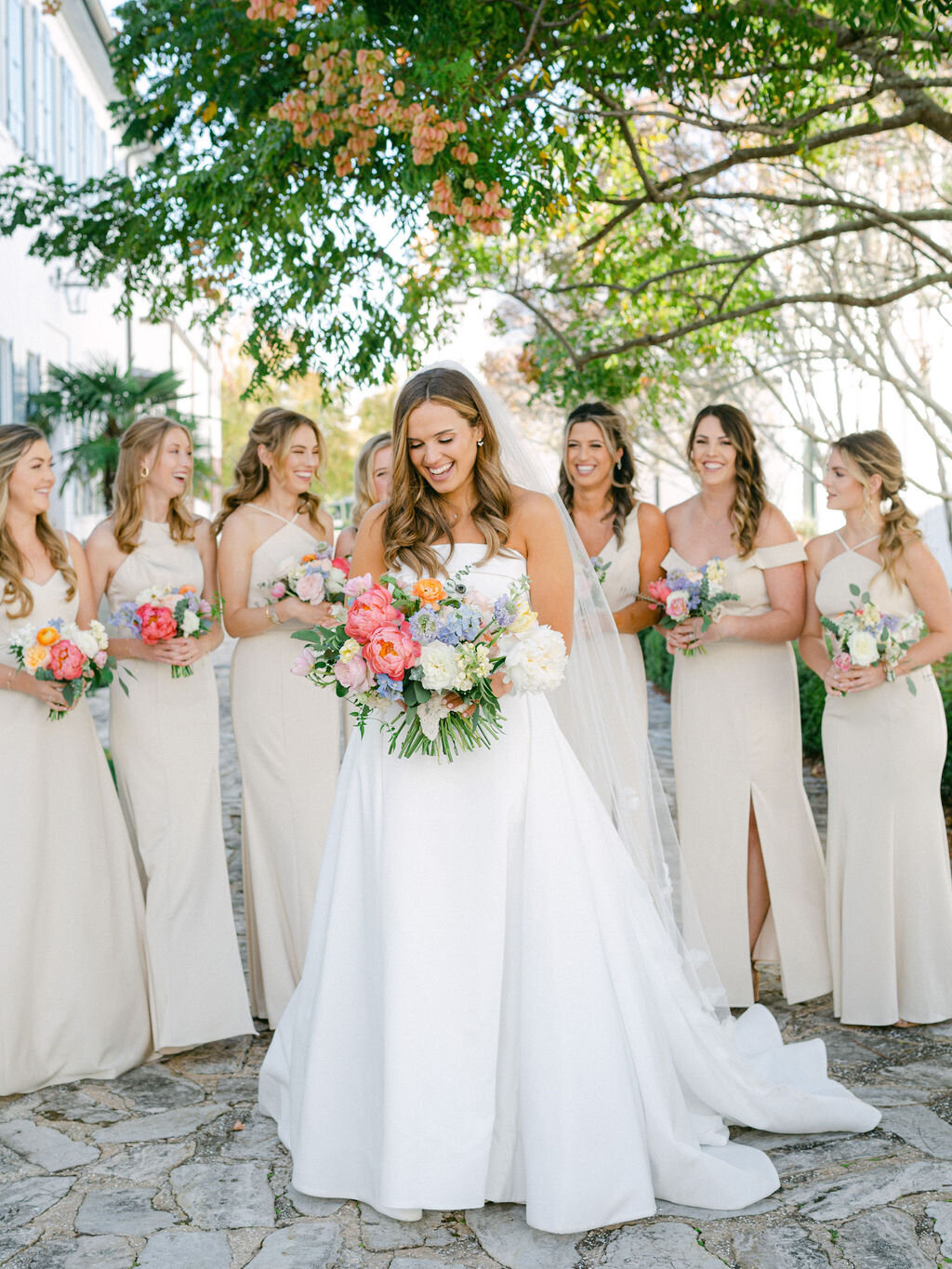 Bride with bridesmaids holding colorful bouquets for Alys Beach wedding