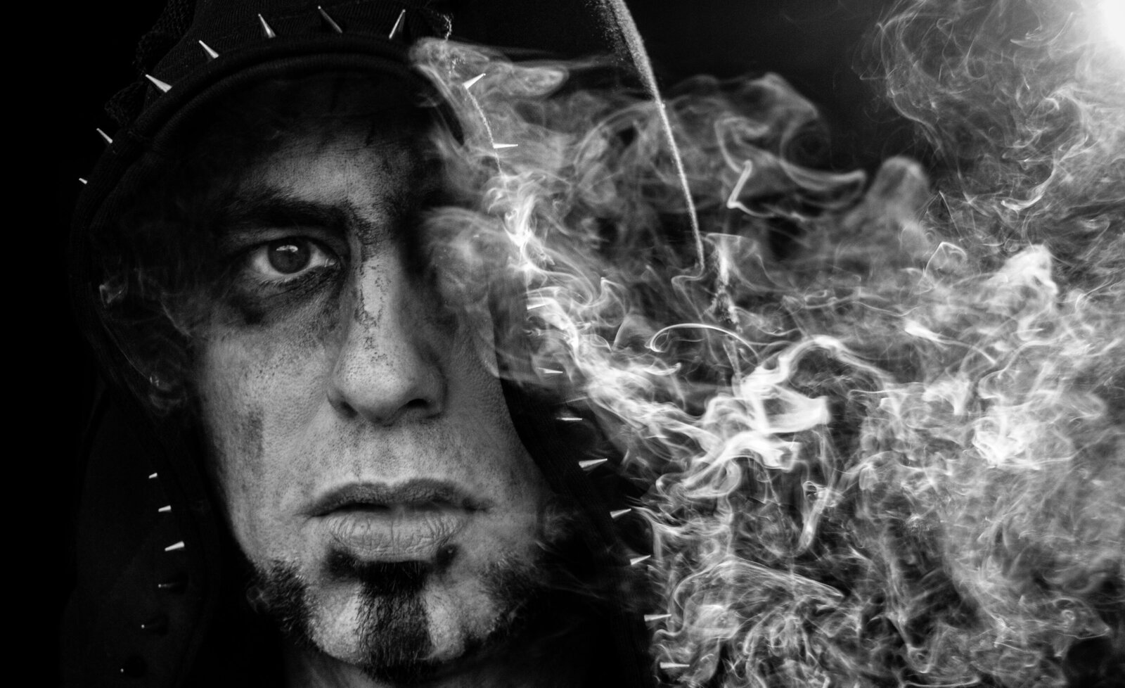 Musician portrait Brock Starr black and white close up with smoke blowing out on side
