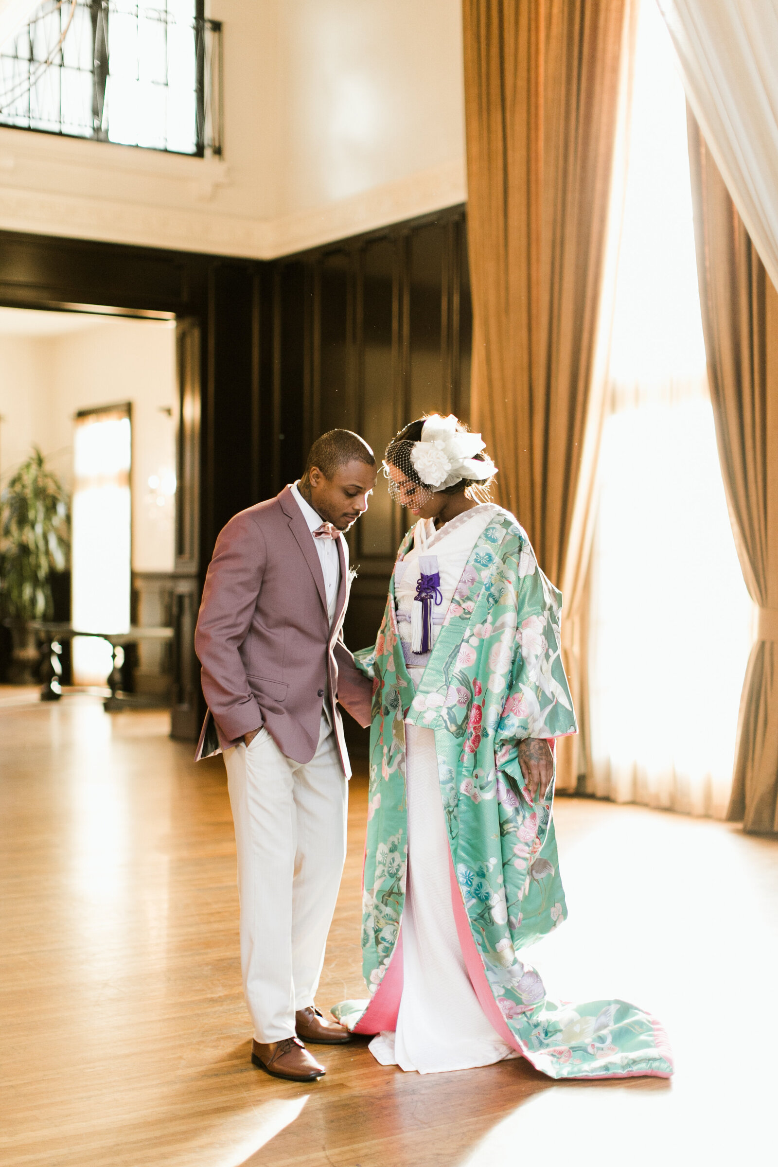 Elegant wedding portrait of bride in mint green floral kimono and groom in mauve jacket inside The Ebell Club Long Beach grand hall, kimono rental Los Angeles | ロサンゼルスThe Ebell Club Long Beachの大ホールでミントグリーンの花柄着物レンタル花嫁と新郎の上品なウェディングポートレート