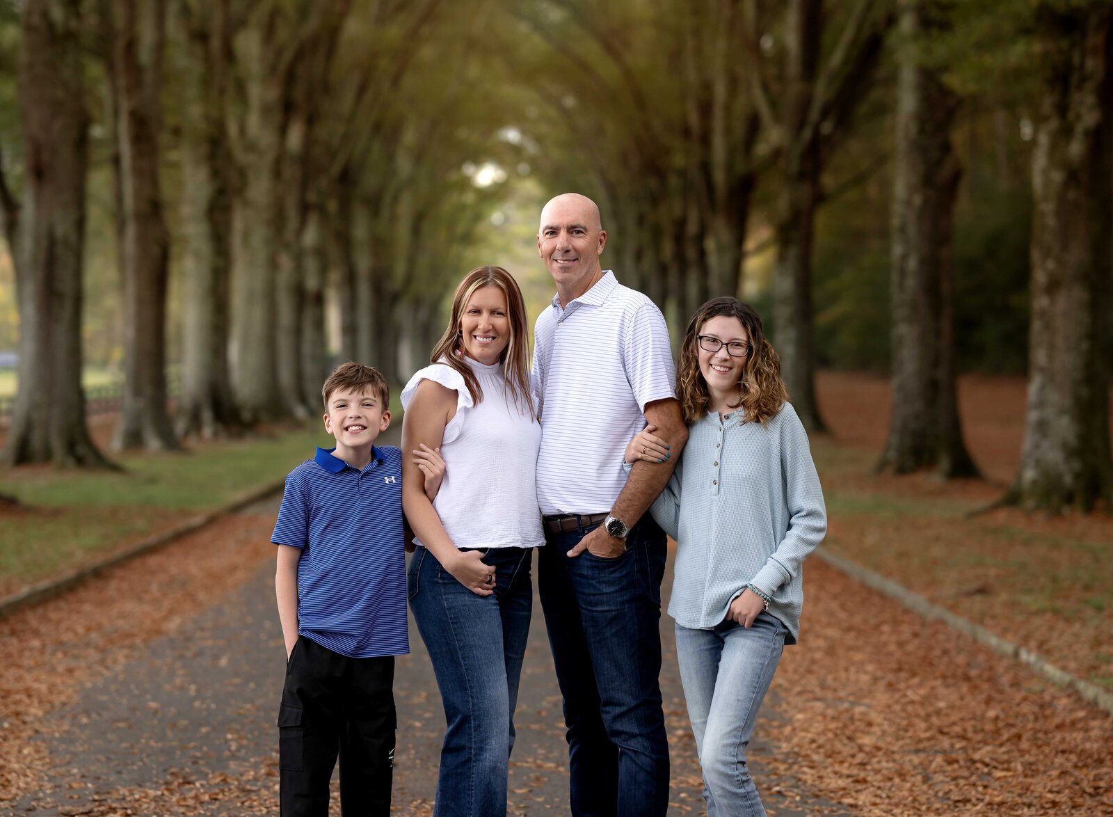 Family of 4 posing for a family photoshoot. Family Photography by Jenni Nikki Photography- Atlanta Family Photographer.