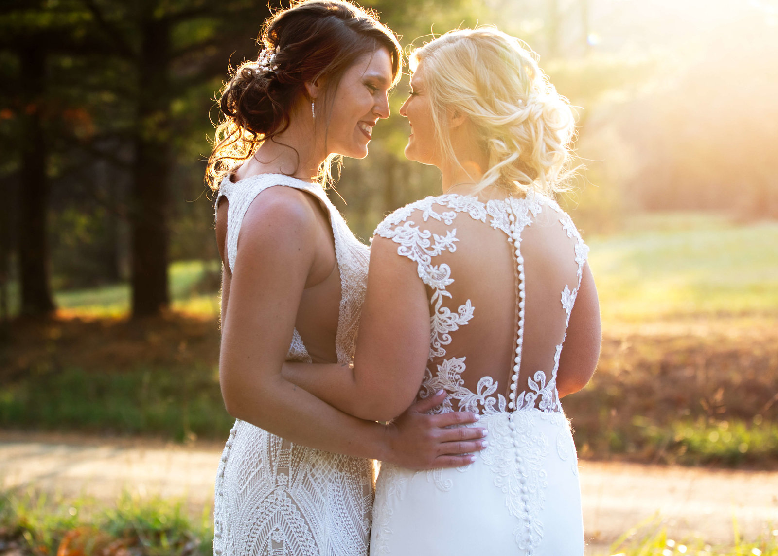 two brides pose together at sunset