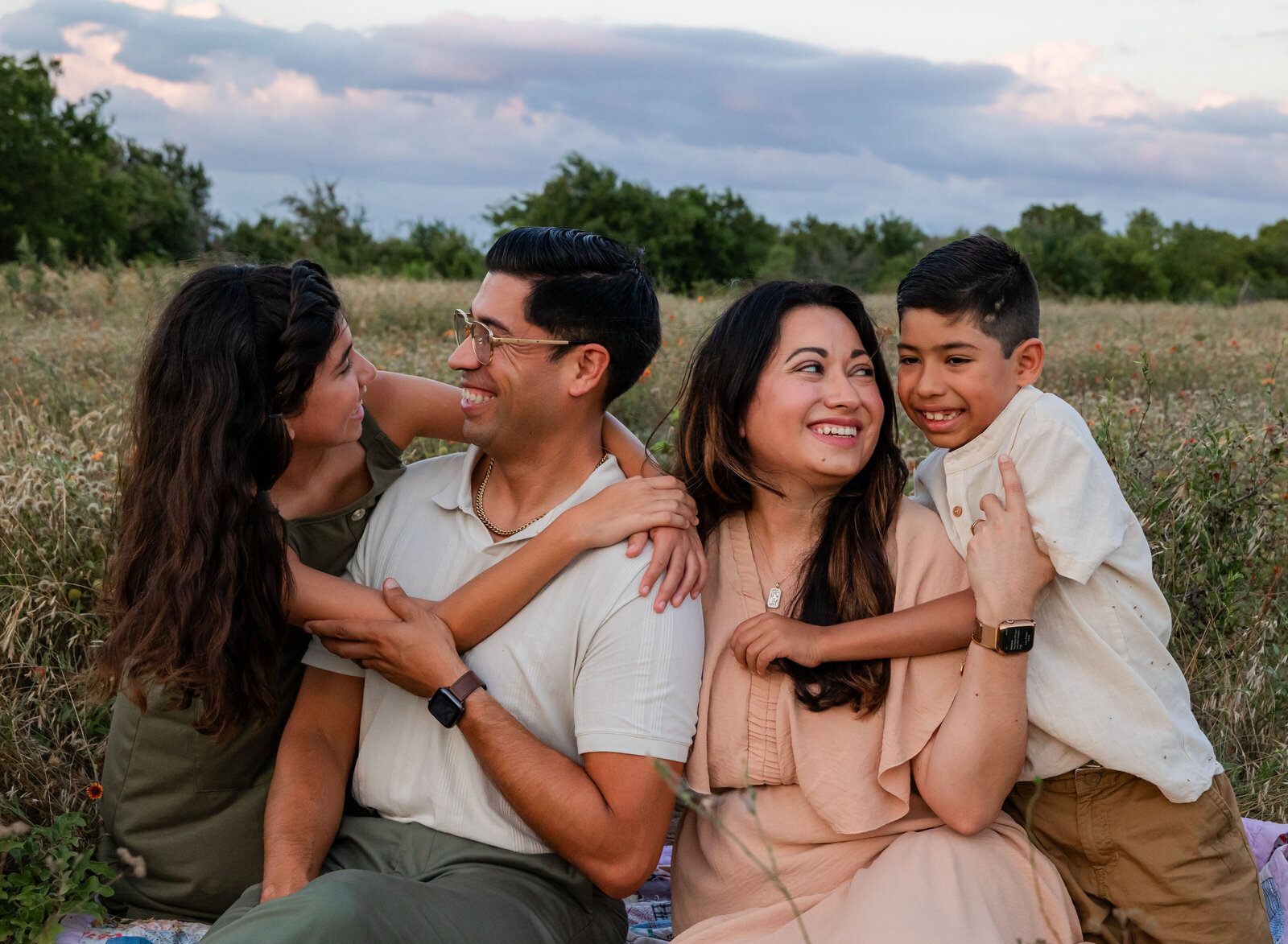 family hugging in field