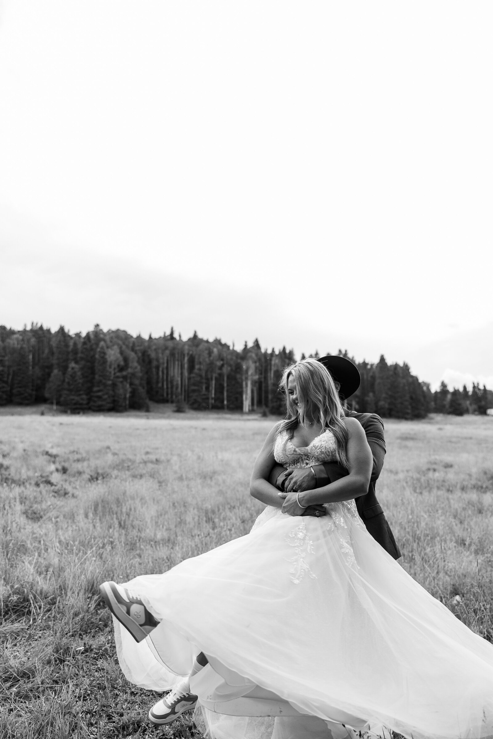 A playful spin and laugh in this black and white capture of the bride and groom