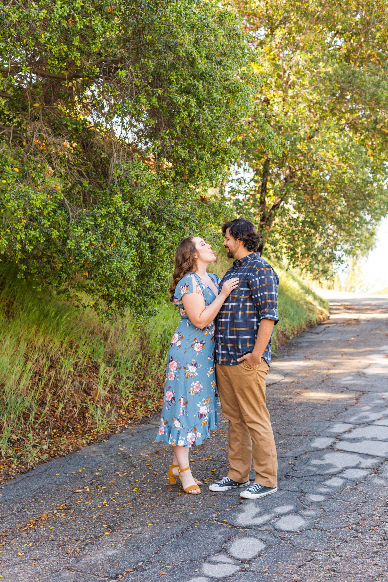An engaged couple poses for photos in a garden in Los Angeles, Ca.