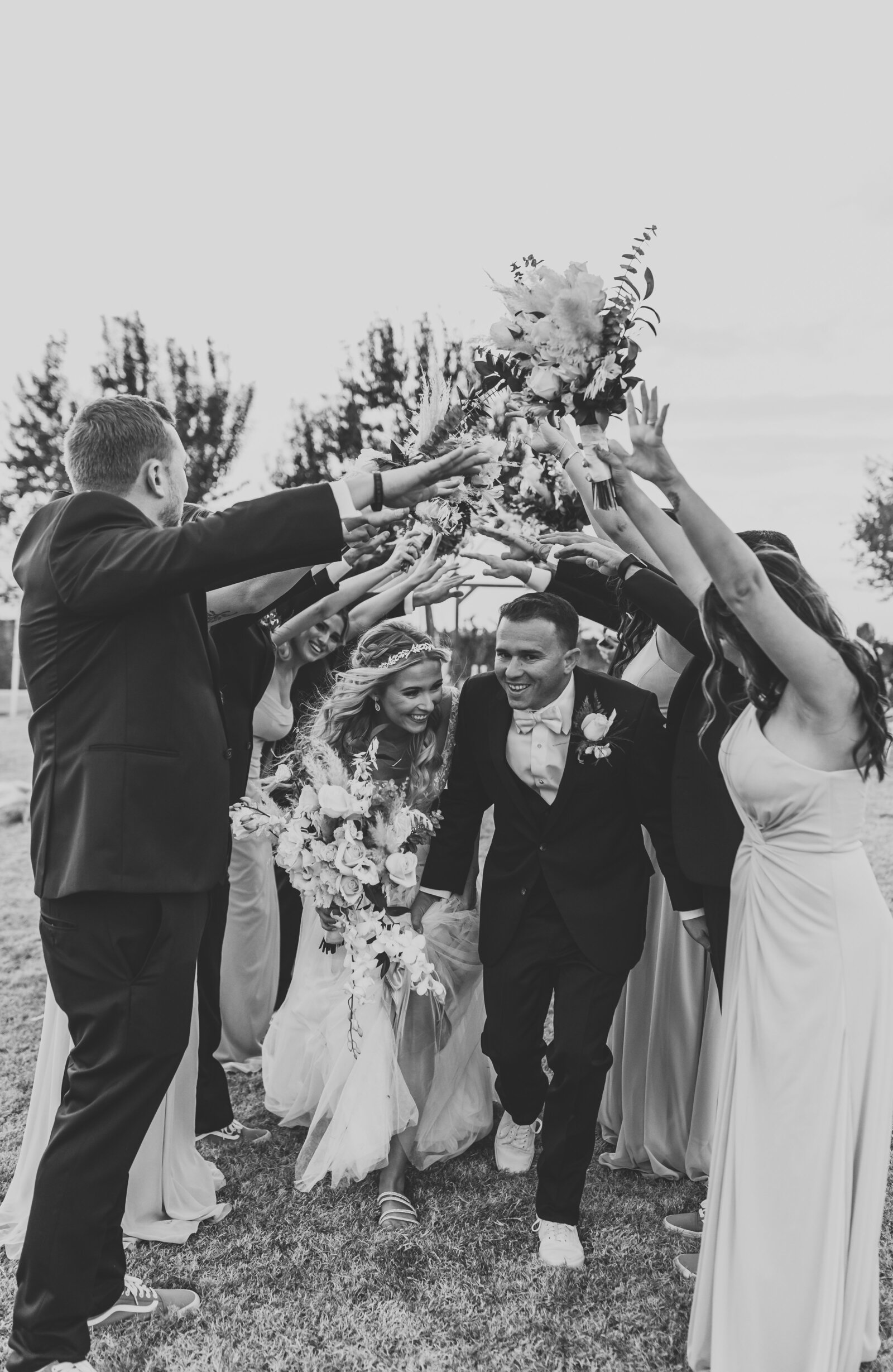 bride and groom walking through a tunnel of friends